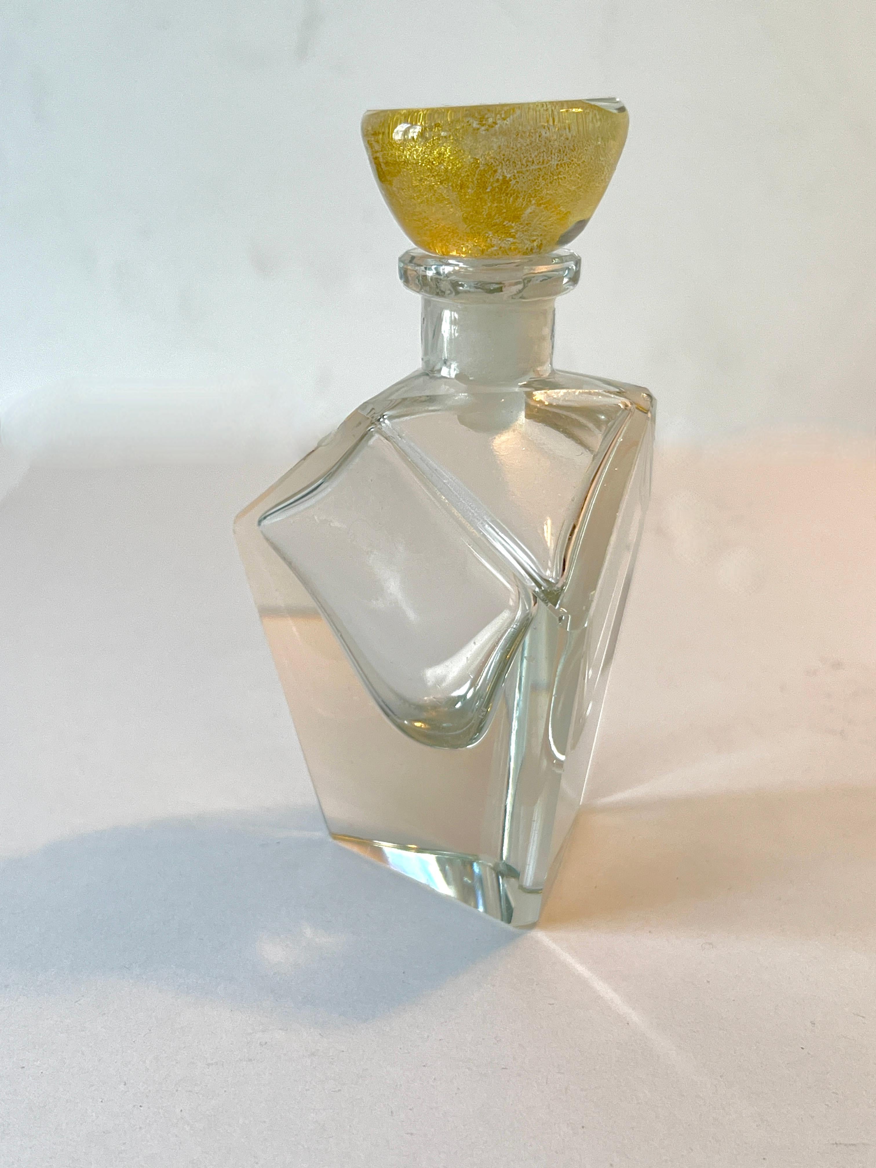 a beautiful multi sided crystal perfume bottle with stopper.  The stopper has flecks of real gold  - the faceted sides and gold top are a wonderful combination.  Simple, Chic and Architectural.

A complement to any dressing table, vanity or special