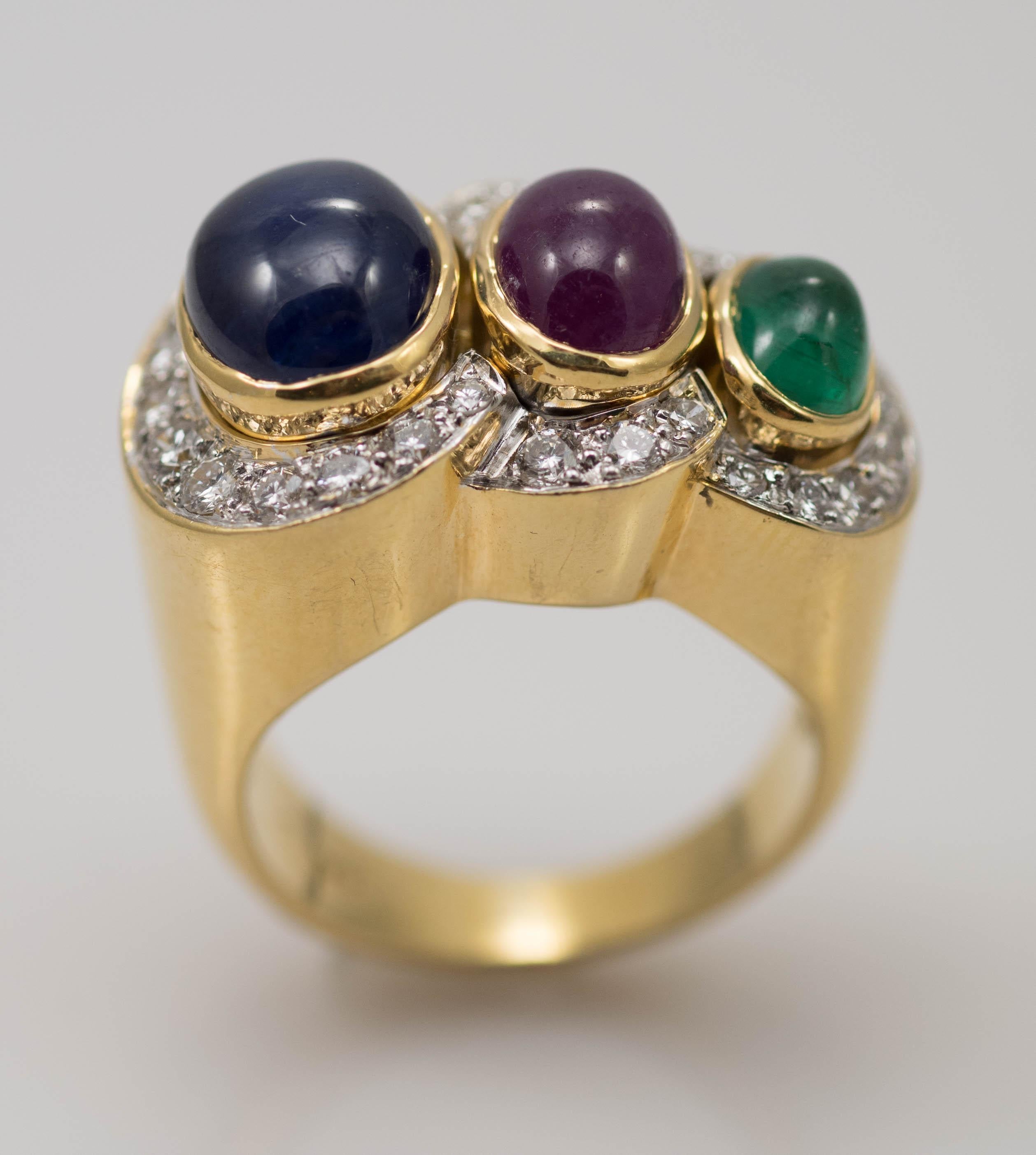 Ladies multi-stone and diamond ring in 18 karat yellow gold.
Stamped 18k and weighs 18.1 grams.
The colored stones are natural cabochon cut, 10 x 7mm blue sapphire, 8x 6mm ruby and 6.5 x 5mm emerald.
On the sides are round brilliant cut diamonds,
