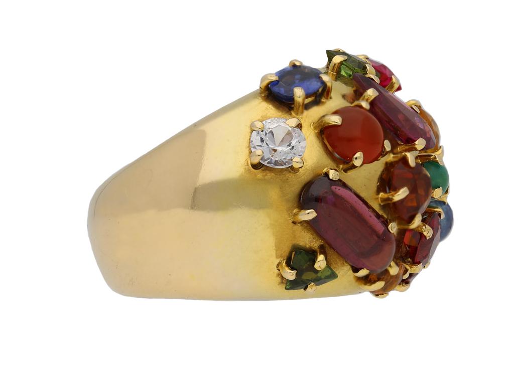 Multi-stone cluster ring. Set with various coloured stones, some faceted some cabochon, including diamond, sapphire, amethyst, citrine, tourmaline, topaz, cornelian, peridot, turquoise and garnet all in open back claw settings, to a broad bombé