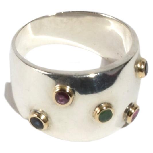 Stunning vintage ring with gold detail and petite faceted ruby, amethyst, tourmaline, and sapphire stones. Stamped 925.

Material: Sterling silver, 14k gold, ruby, amethyst, tourmaline, sapphire.

We recommend storing in a dry place and periodic