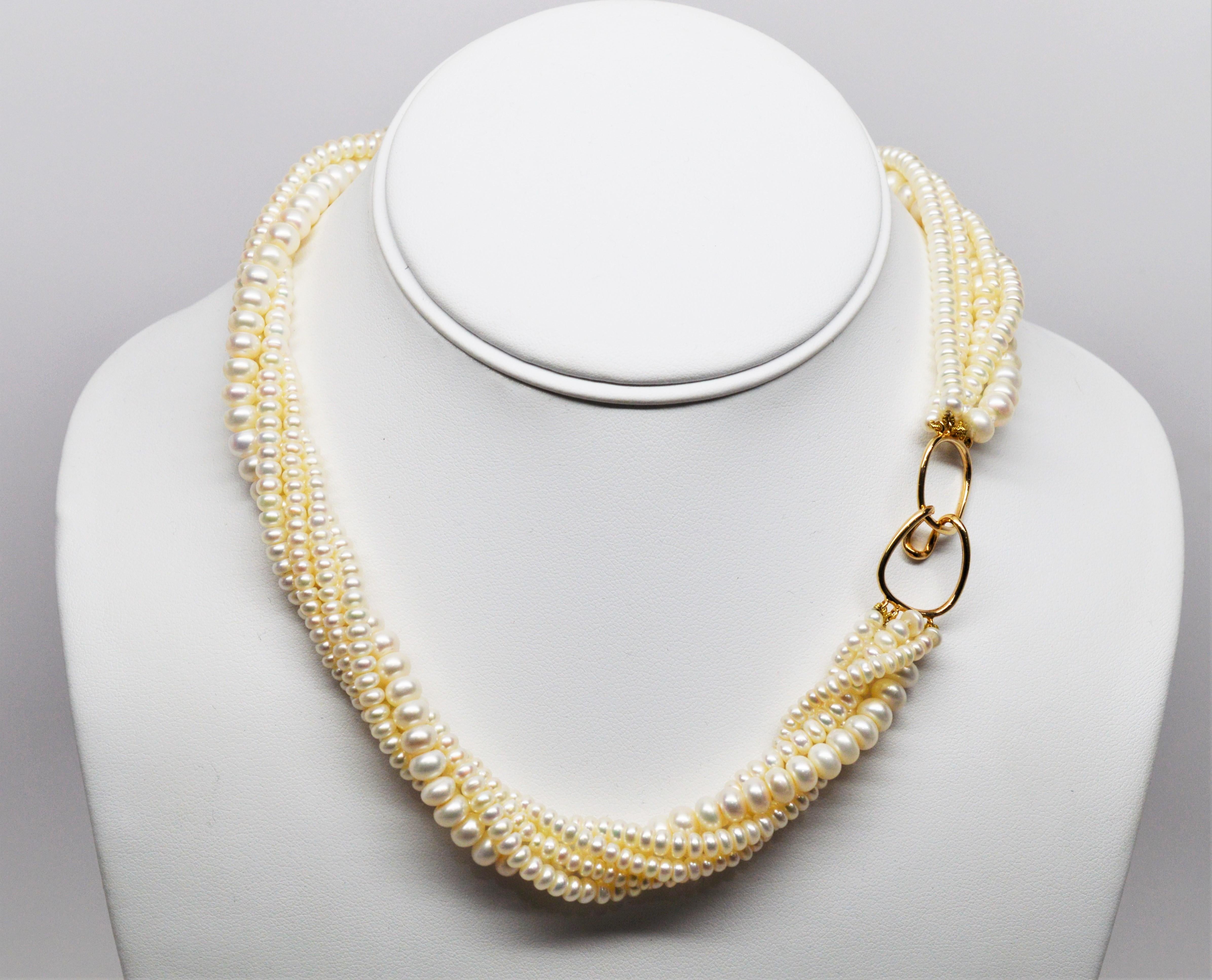 Smart and sophisticated with multiple sixteen inch strands of natural AAA Akoya button pearls ranging in size from 3-1/2 mm to 5-3/4 mm finished with a fourteen carat yellow gold hook clasp. Can be worn in twist or draped for different looks. In