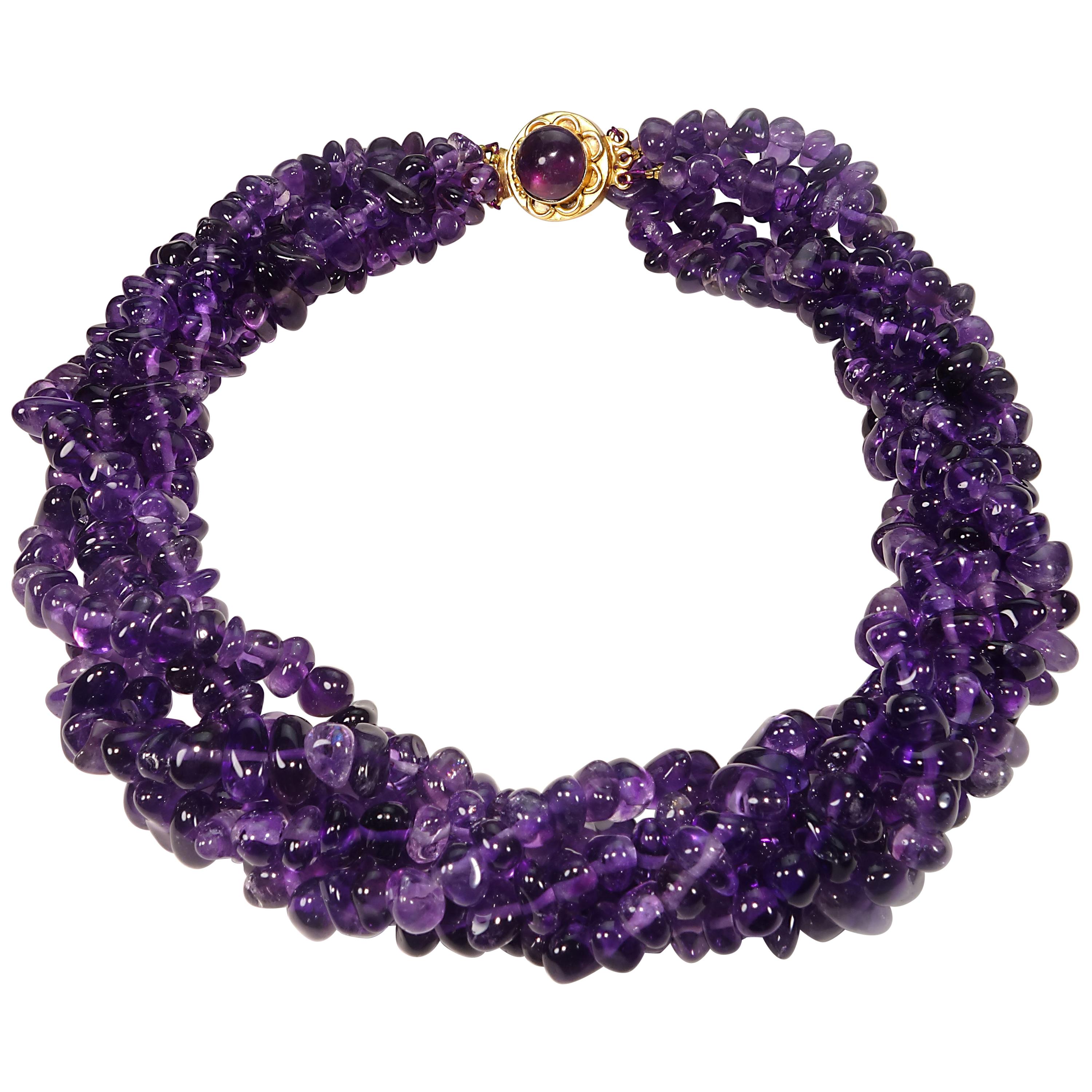 Five strands of custom made, highly polished, tumbled Amethyst, approximately 4-6mm,   in a stunning bright purple necklace.  The necklace can be twisted to shorten to choker length.  This unique necklace is secured with a gold tone box clasp with