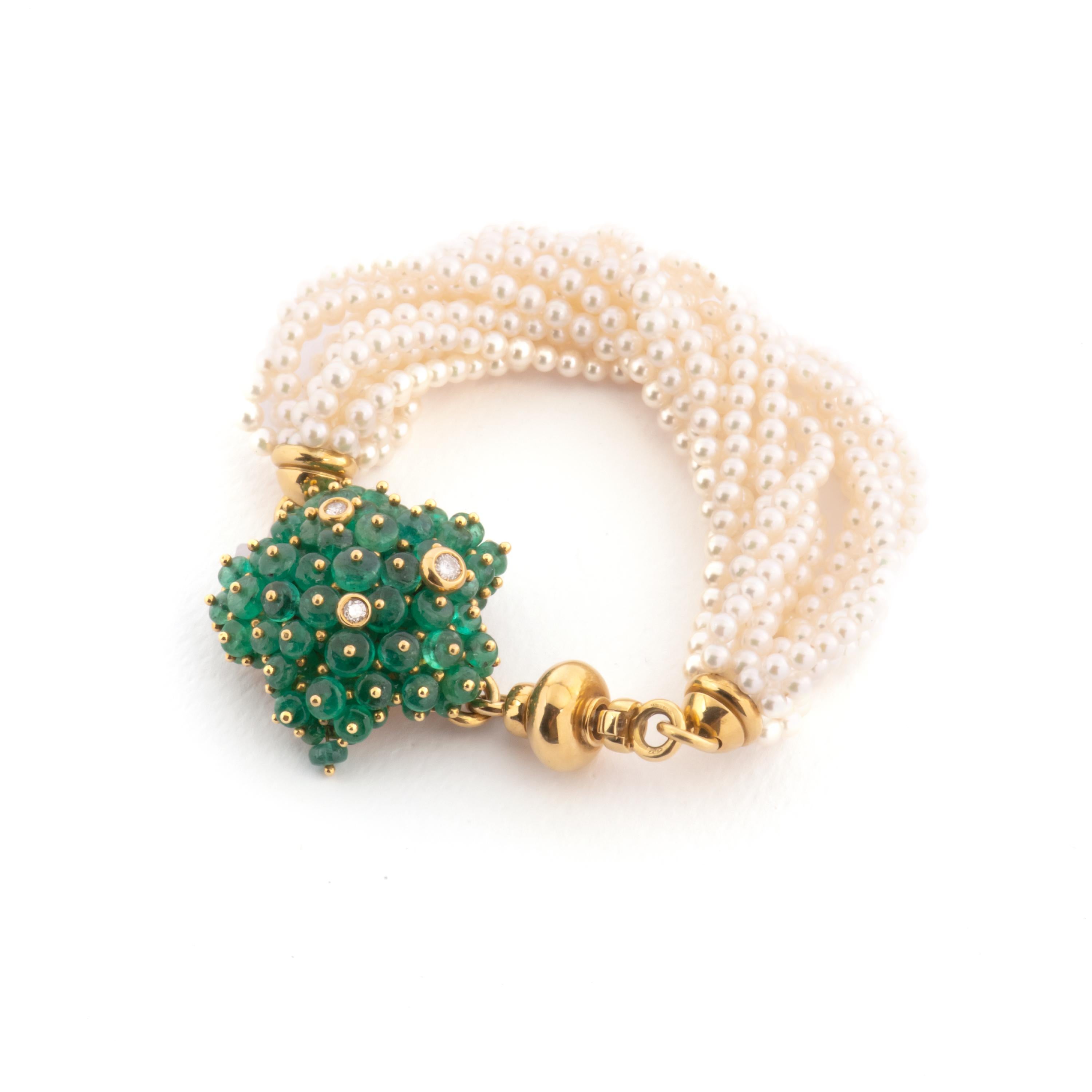 Multi strand bracelet, crafted with pearls. 18k yellow gold clasp decorated with emeralds  cabochon cut  and diamonds.  Clasp Marked Gioielmoda Pasquale Bruni. 
