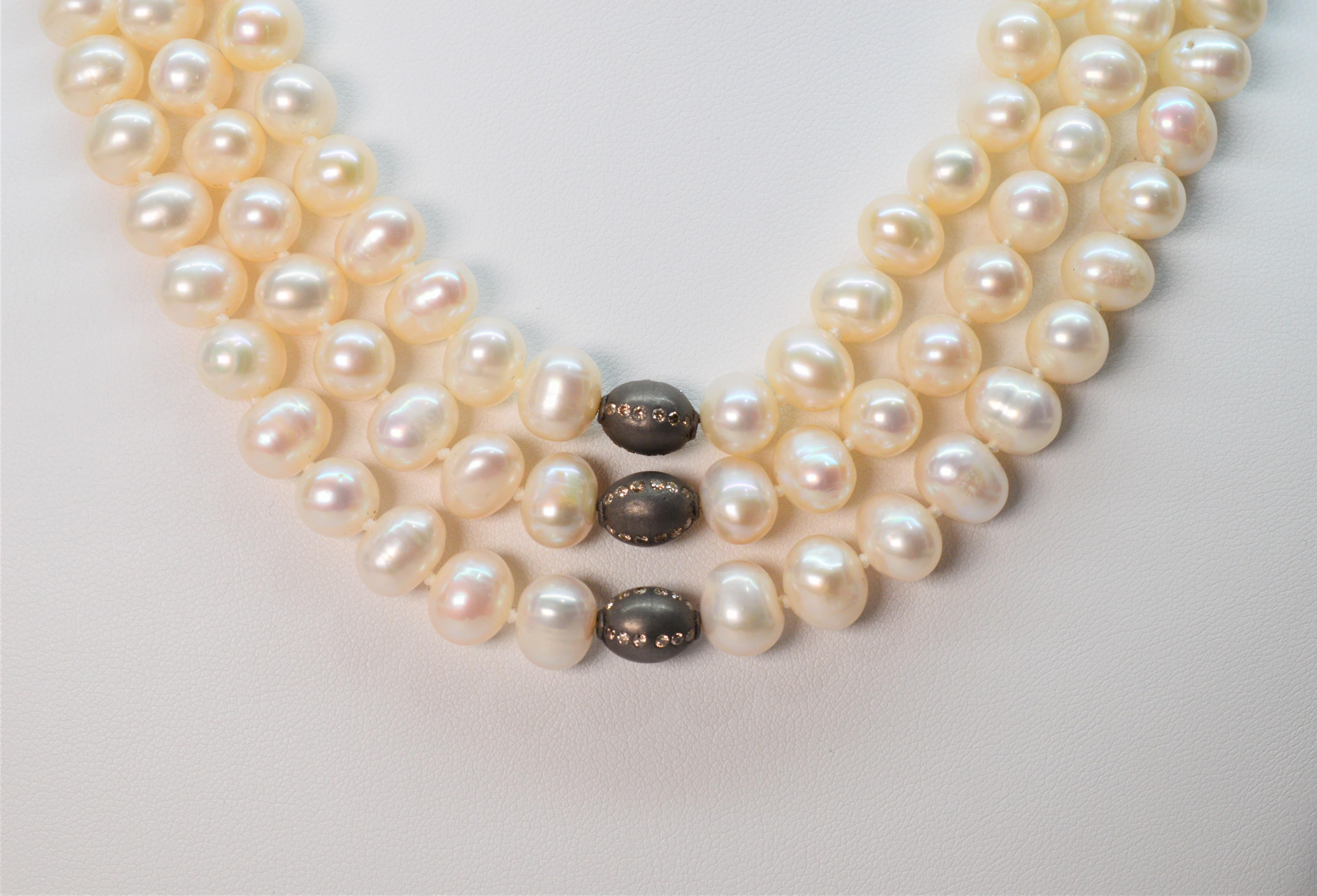 Three luscious strands of lustrous 8.5/9mm genuine creamy white button pearls beautifully drape to create this statement piece. A perfect accessory piece to elevate your wardrobe basics, each graduating pearl strand is defined with a unique diamond