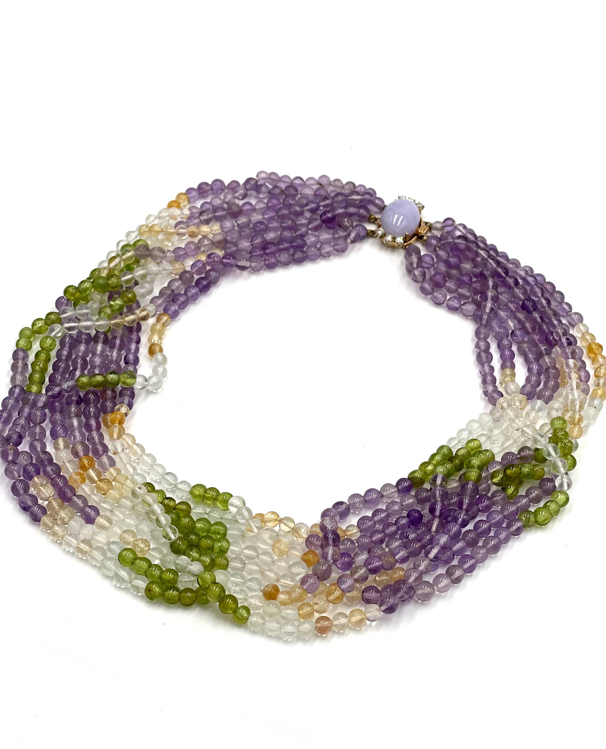 Pre owned vintage estate multi strand necklace consisting of 4.7-5mm beads made of amethyst, citrine, clear quartz and peridot.  The clasp is 14K white and yellow gold with one lavender jade measuring 17.5X13.0X7.8mm and six round brilliant-cut