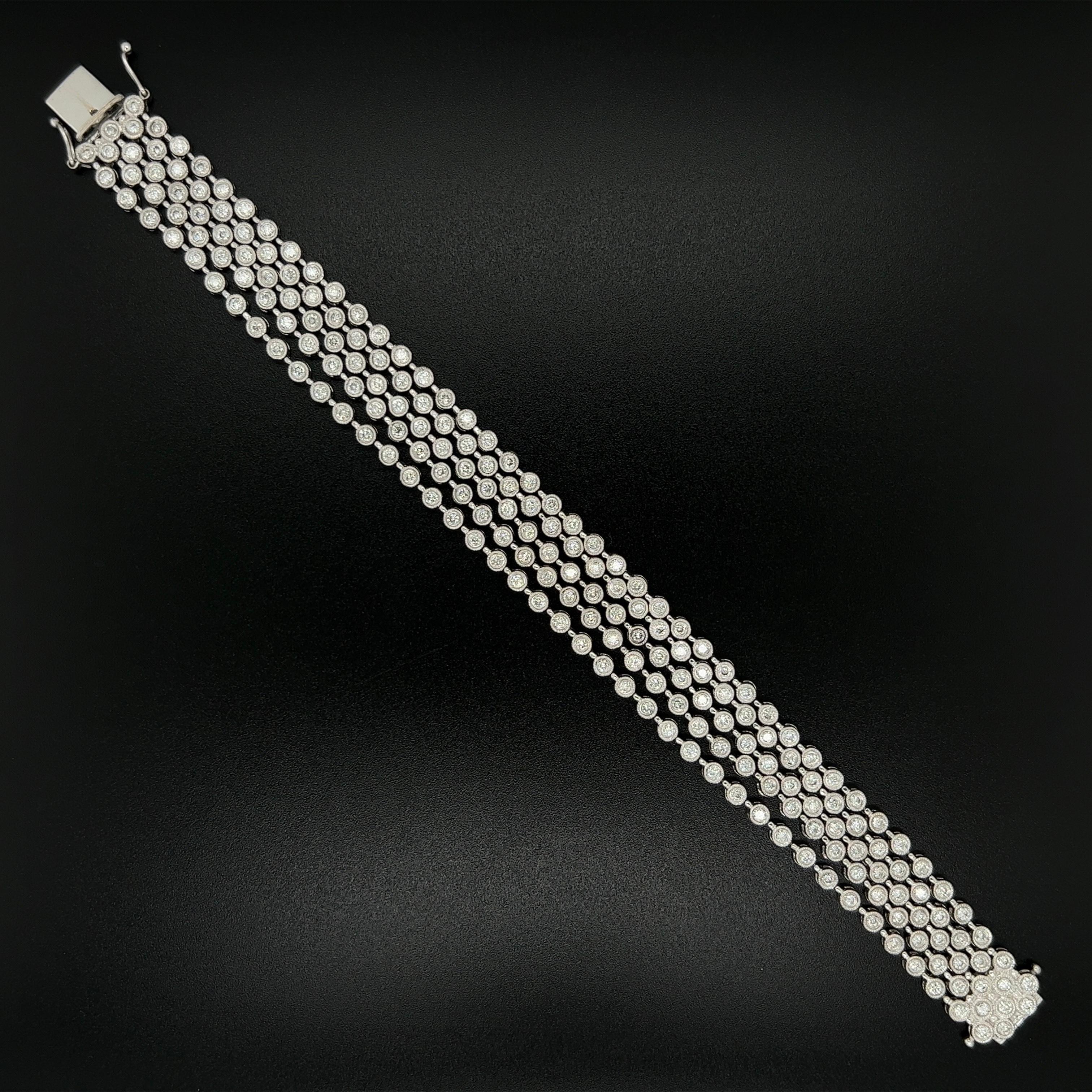 Simply Beautiful! Finely detailed 5 Strand Diamond Bracelet held by a Diamond encrusted clasp. Bezel Hand set with 4.20tcw Diamonds. Measuring approx. 7” l x 0.50” w. Hand crafted in 18K White Gold. More Beautiful in real time...A piece you’ll turn