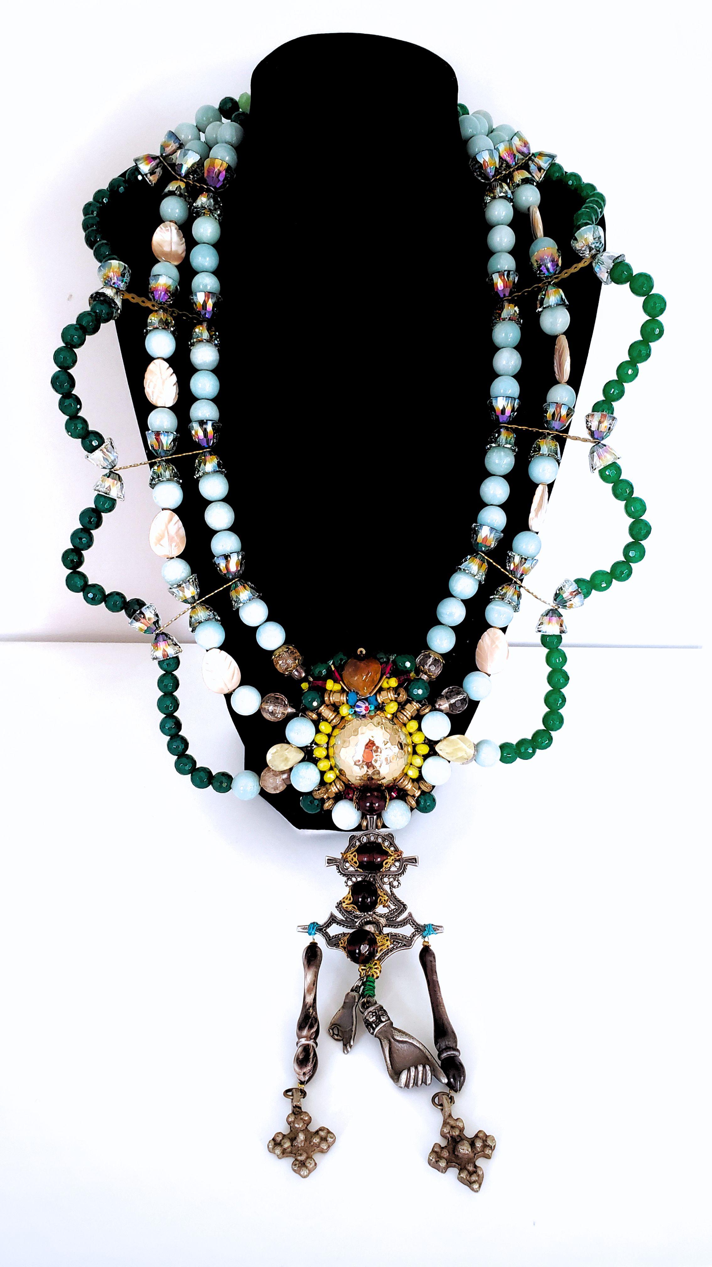 This elaborate multi-strand embellished gemstone And Swarovski crystals statement necklace I have designed from a unique perspective. It is an accumulation and celebration of culture, travel, creativity, and artisanship. Not only is this necklace