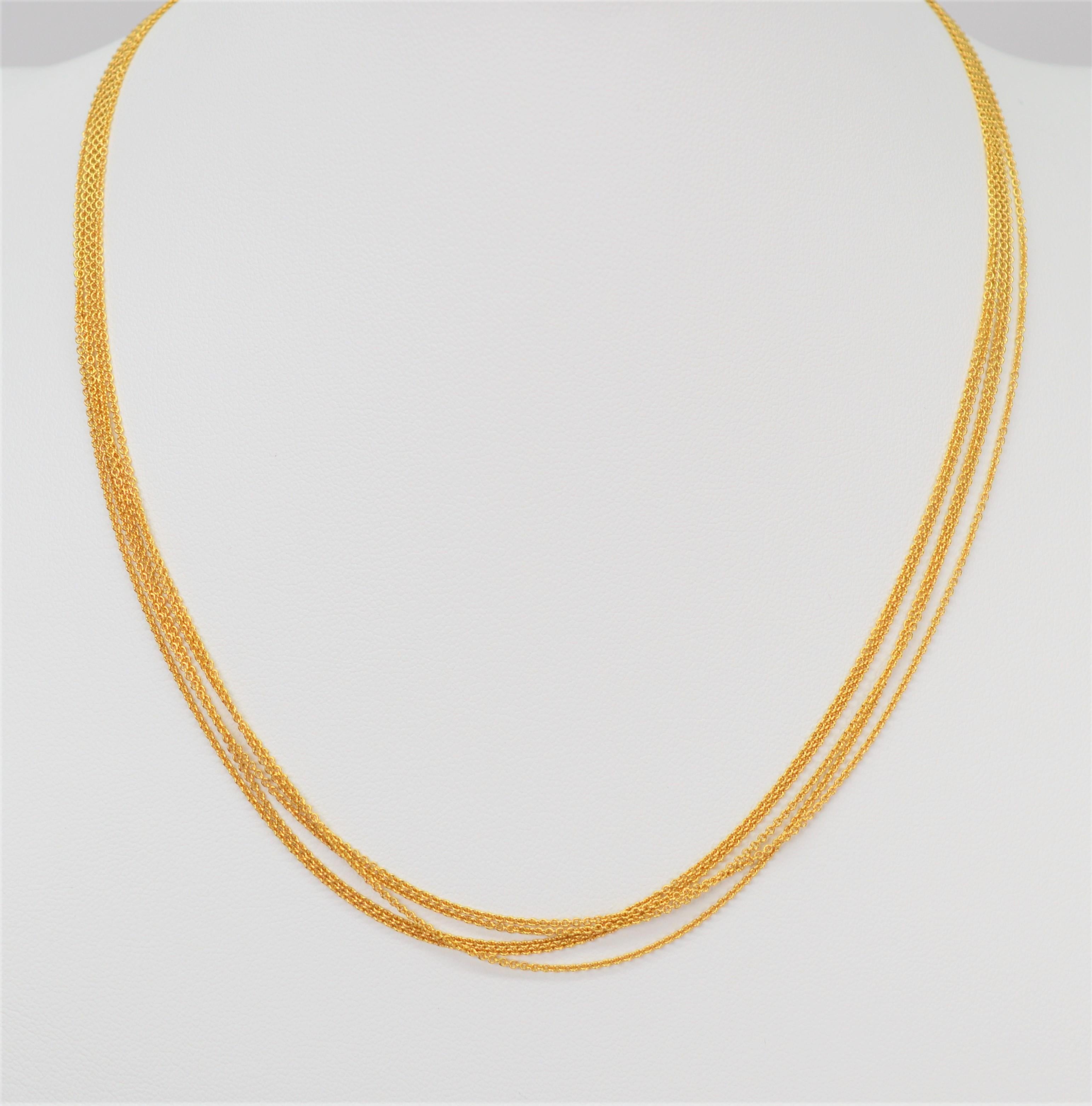 Simple yet impactful, five strands of fine one millimeter fourteen karat 14K yellow gold Italian made cable chain are nestled together and drape to form the on-trend multi-layered look of this 16.5 inch necklace. Stamped 14K / Italy and finished