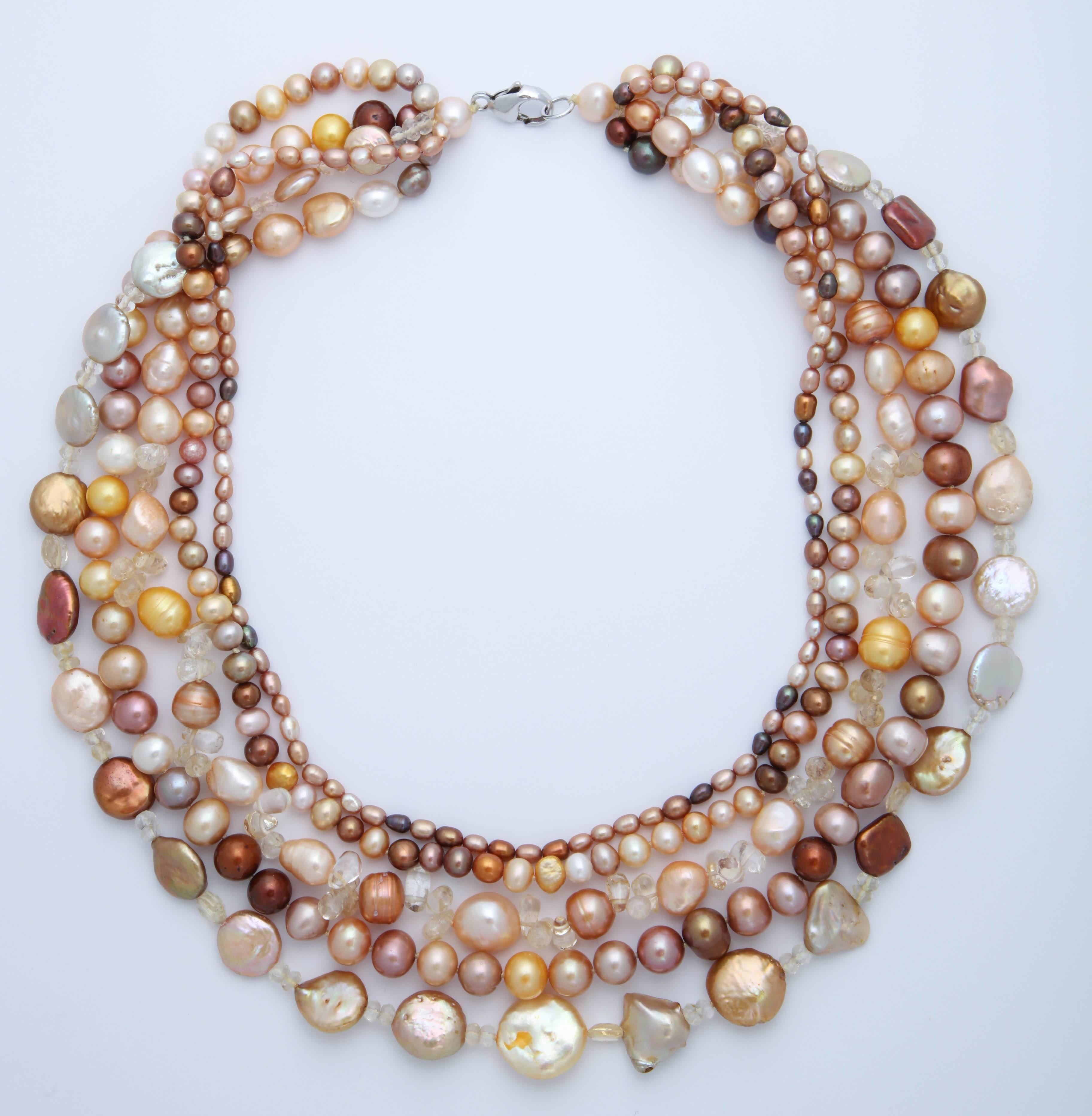 5 Strands of multi color, variations of orange, beige and brown,  and multi shapes and sizes  fresh water pearl necklace. Great colors for any season. Necklace can  be worn flat or twisted. The shortest strand is 18 in. and the longest strand is 21