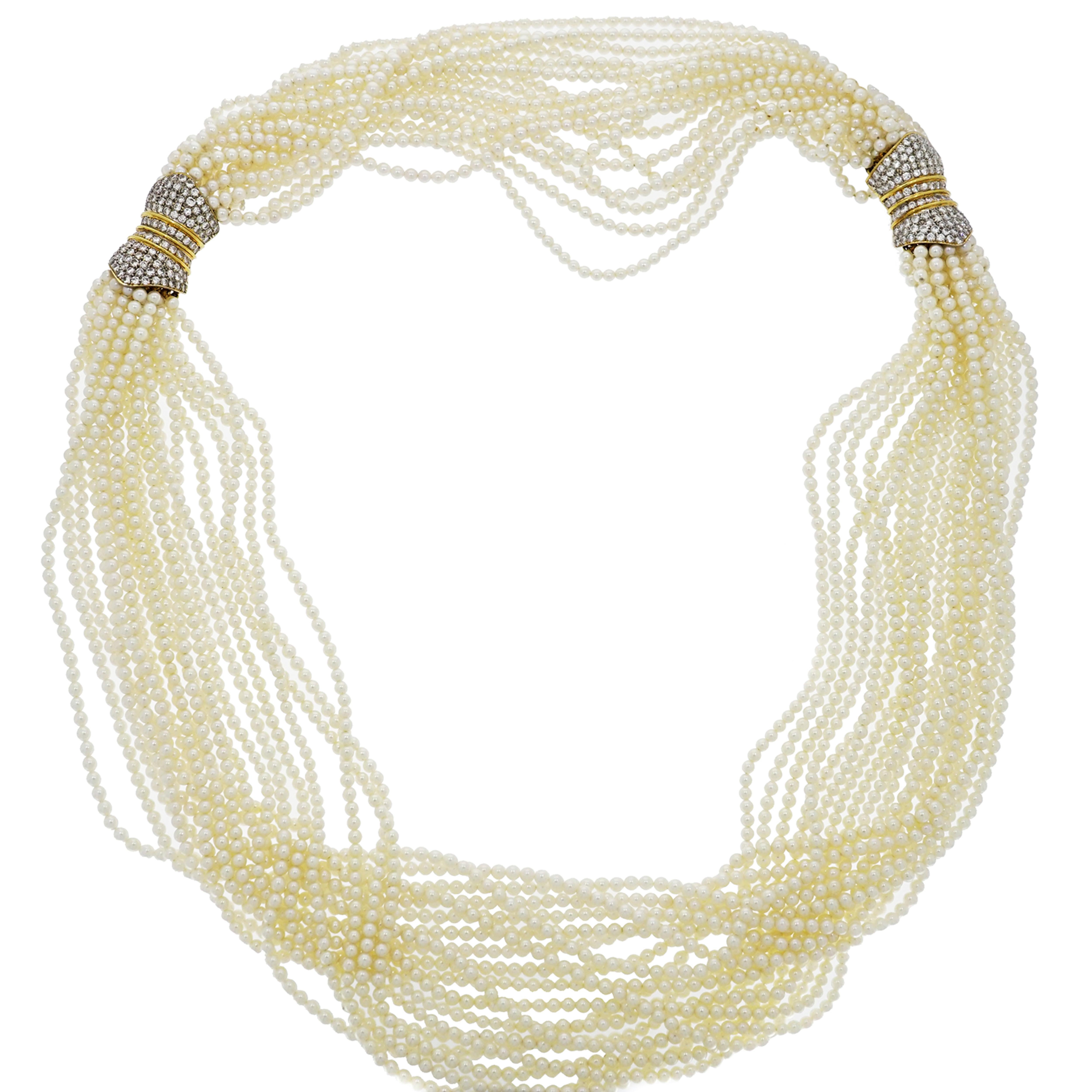 This classic Multi-strand Pearl Necklace features 19 strands of 2.5-3mm Fresh Water Pearls meeting at the unique Diamond crusted Yellow Gold clasp that can be connected with the matching bracelet. Giving you more options to wear it in different