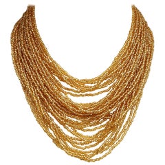 multi strand gold necklace Multi Strand Gold Glass Bead Necklace with Beaded Clasp circa 1960s