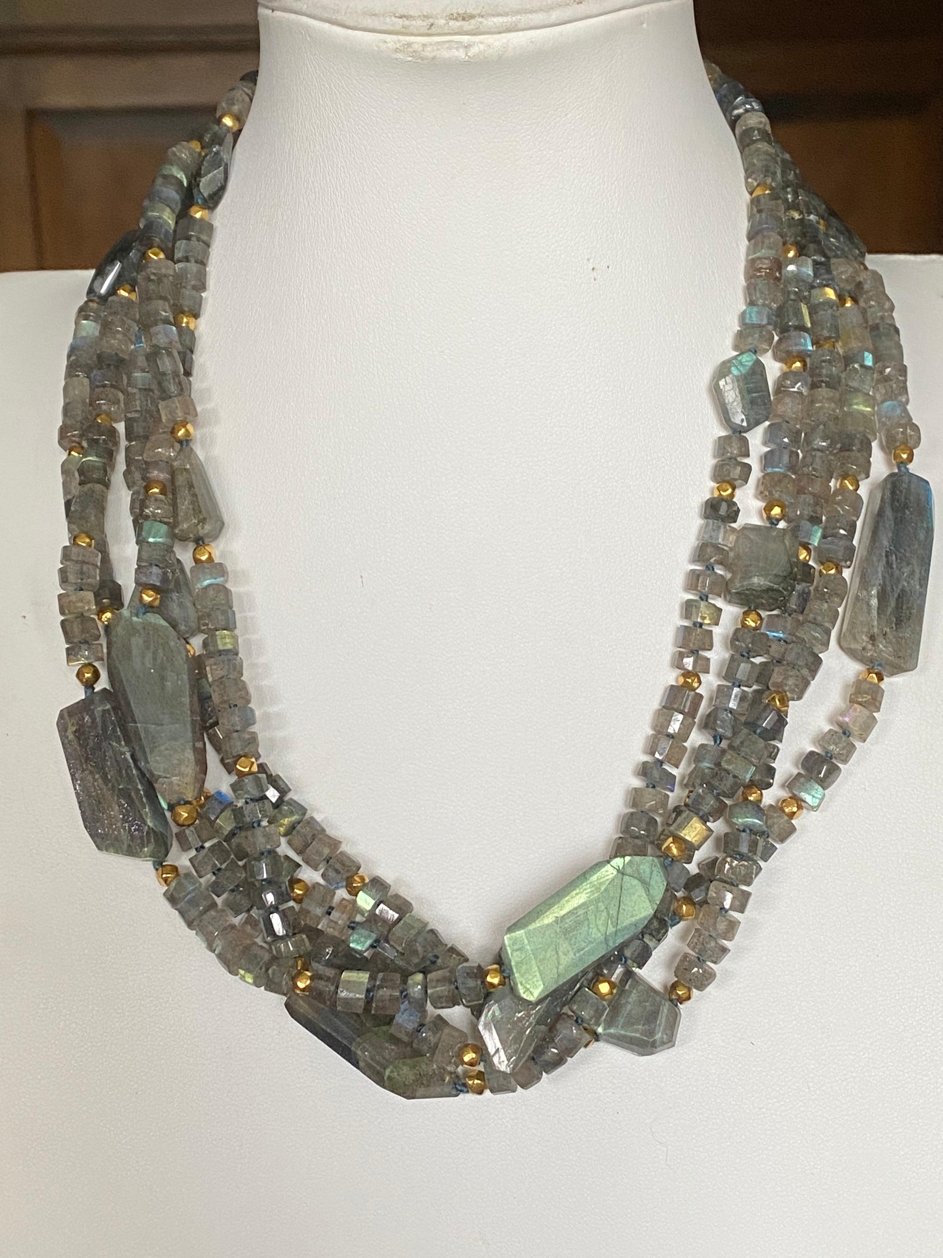 Five strands of beautiful green, blue, yellow, and brown colors in this luscious Labradorite Multi-Strand Necklace. There are gold plated beads and a sterling silver clasp. Measures 18 inches on the neck. Can be wrapped (twisted) or worn as straight