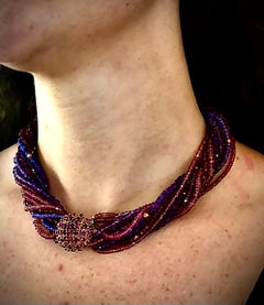 Multi-strand neck. Amythest, tourmaline, iolite w/ 18K gold ruby set box clasp