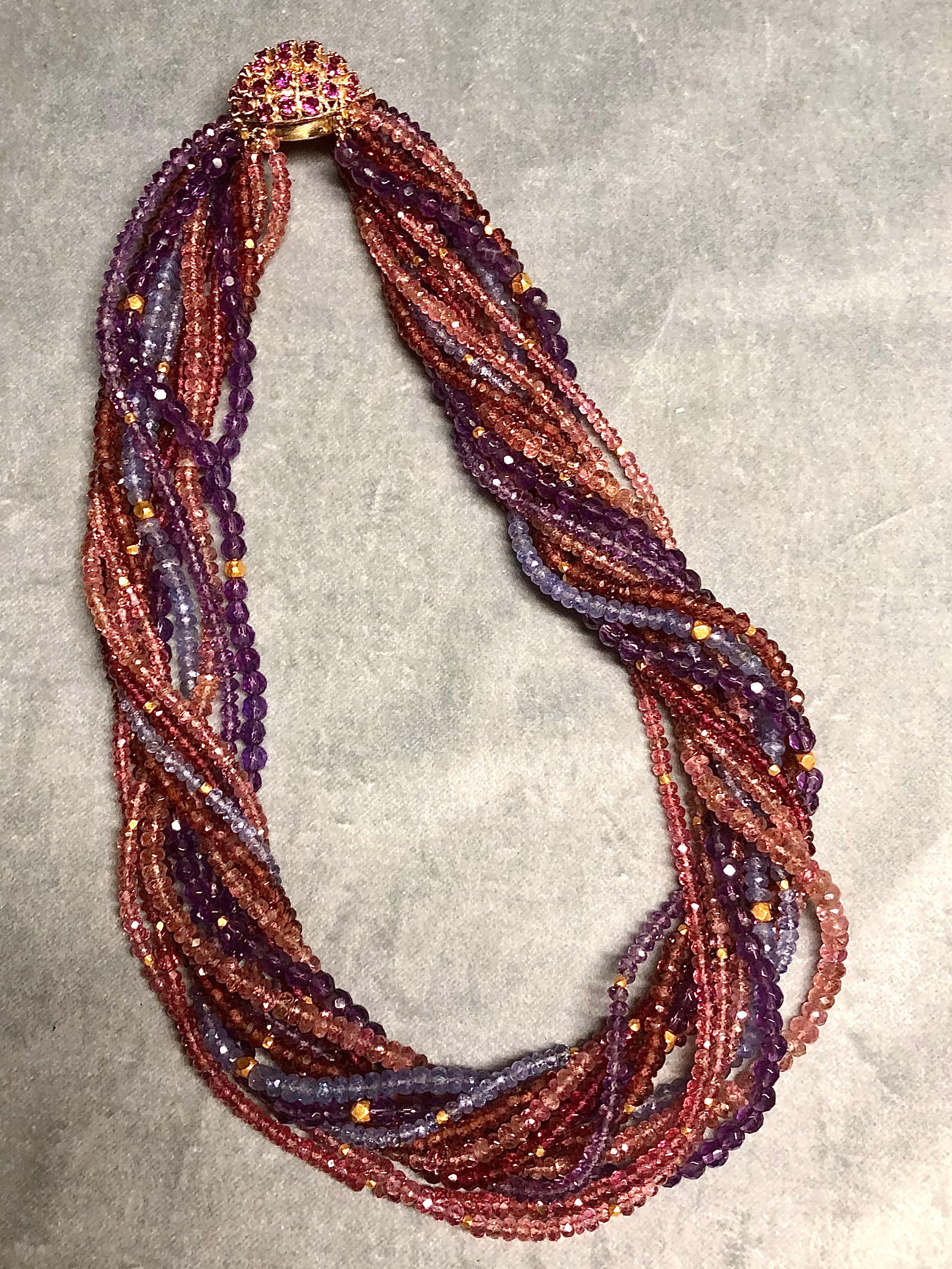 Multi-strand neck. Amythest, tourmaline, iolite w/ 18K gold ruby set box clasp