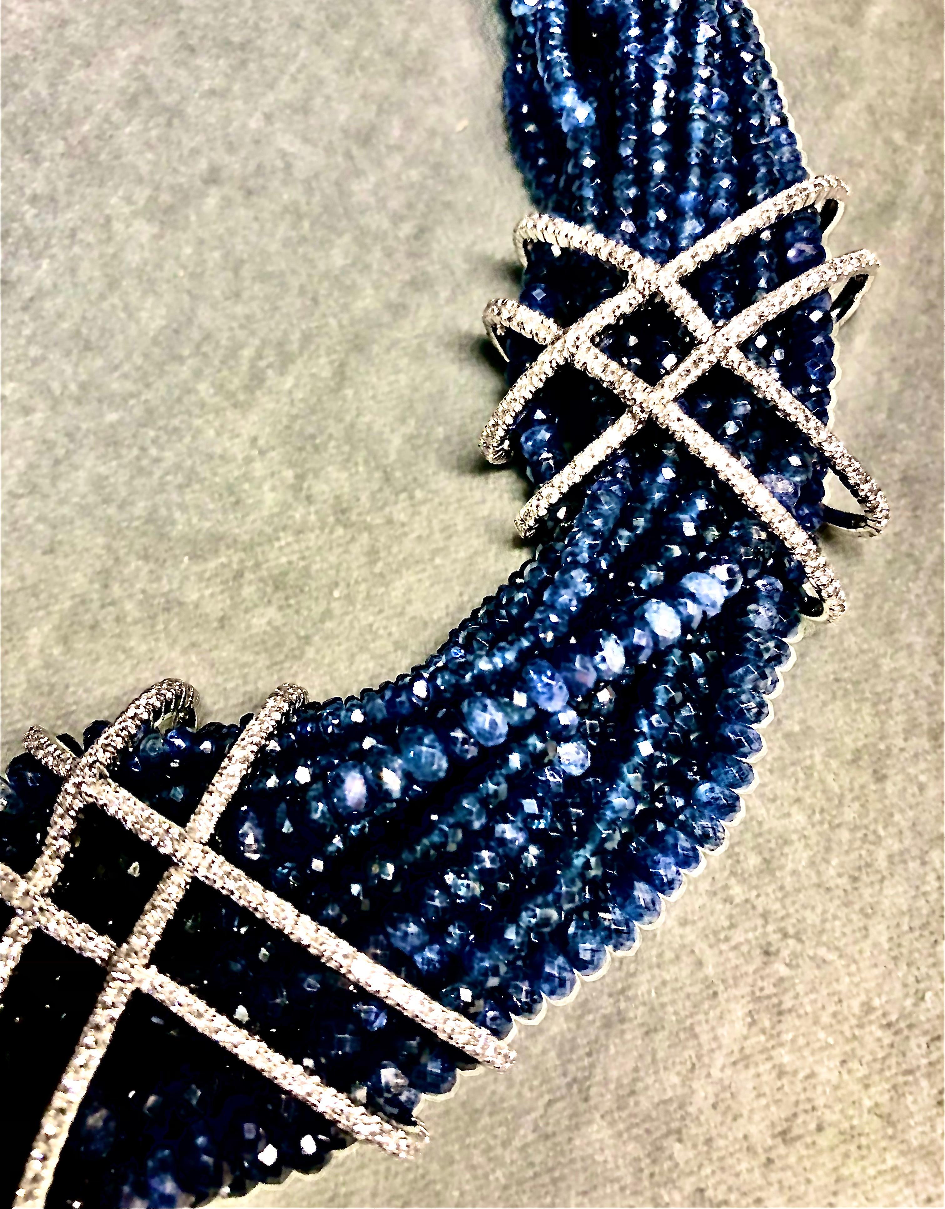 Striking multi strand necklace of deep blue faceted sapphires and diamonds. Sparkling sapphire beads are held in place by diamond bretelles croisees to stunning effect. The necklace secured with a triple diamond pave clasp. This is rich but subtlety