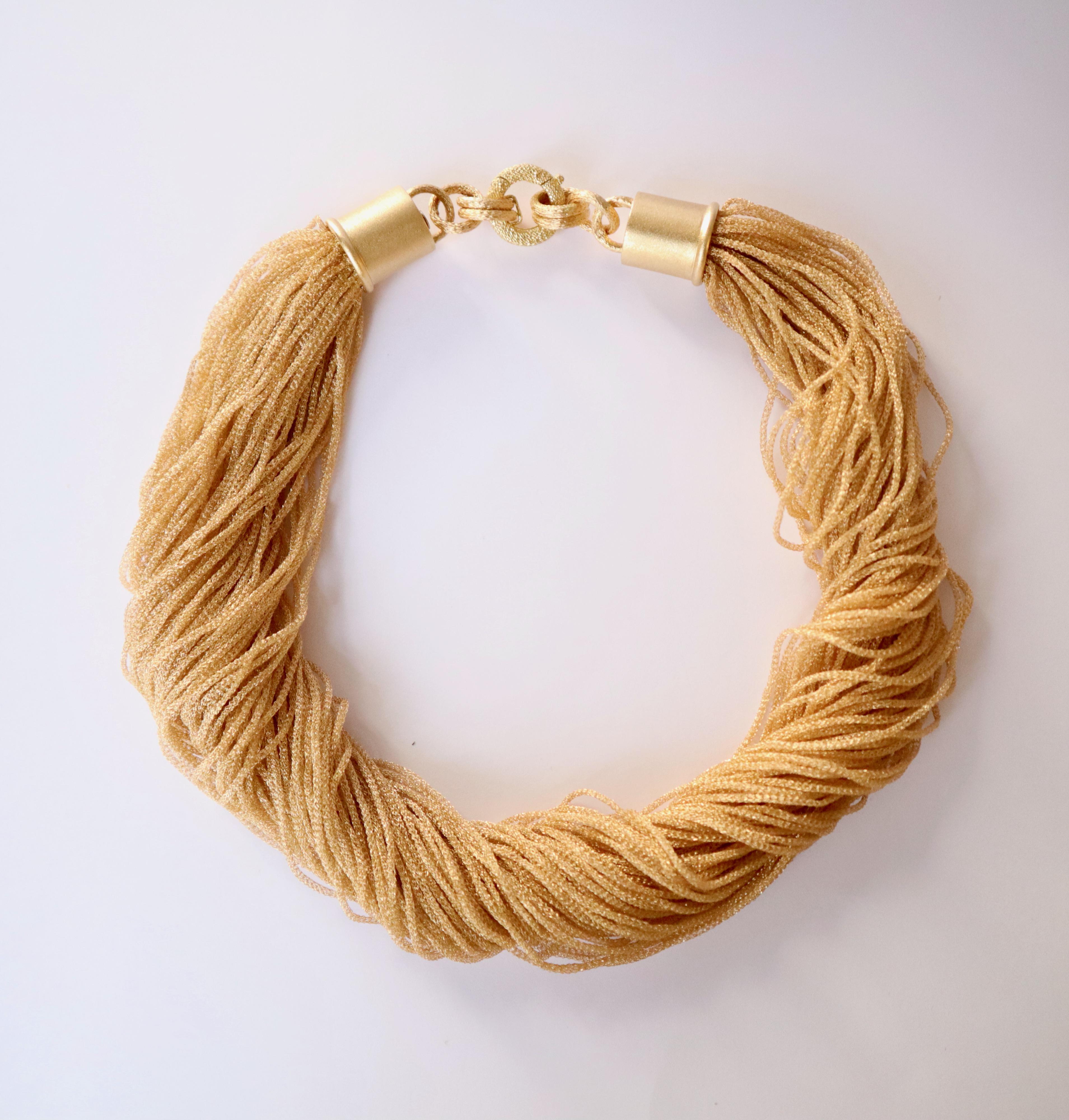 Collana a più fili intrecciati in oro giallo 18kt. È composto da 80 fili intrecciati. 
Può essere indossato con fili arrotolati o con fili posizionati naturalmente sul collo. Nelle foto puoi vedere due modi di indossarlo.
Peso: 97g 
Lunghezza: 47