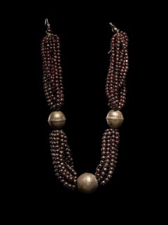 Multi-strand necklace of glass beads with brass elements.