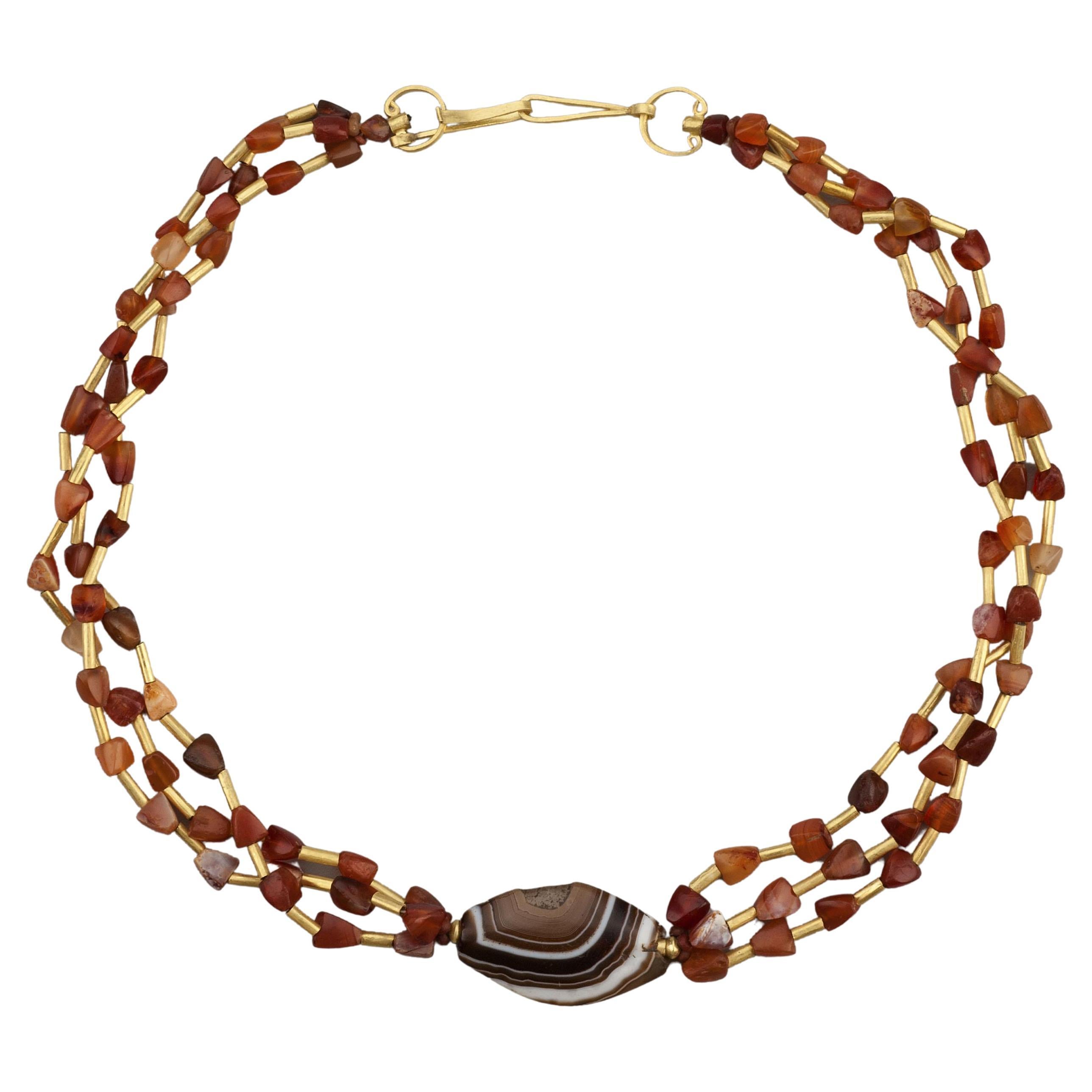 Multi Strand Necklace with Carnelian, Gold Tubes, and Trapezoidal Agate Center For Sale