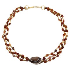Multi Strand Necklace with Carnelian, Gold Tubes, and Trapezoidal Agate Center
