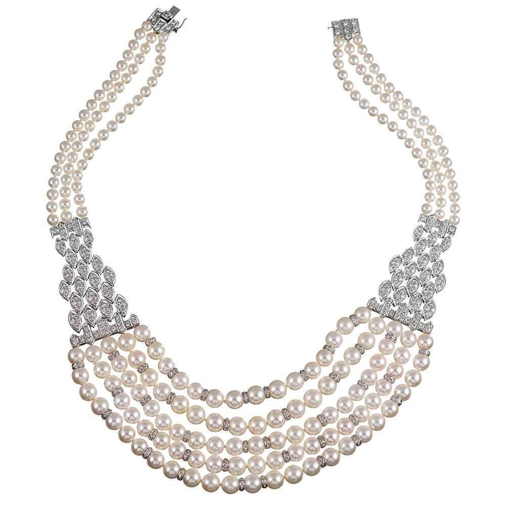 Sophisticated and feminine, this five strand pearl necklace tapers to three strands at the back and is finished with a diamond-studded clasp and safety. The sections are connected by textured bridges of diamond links. Note the diamond rondelles