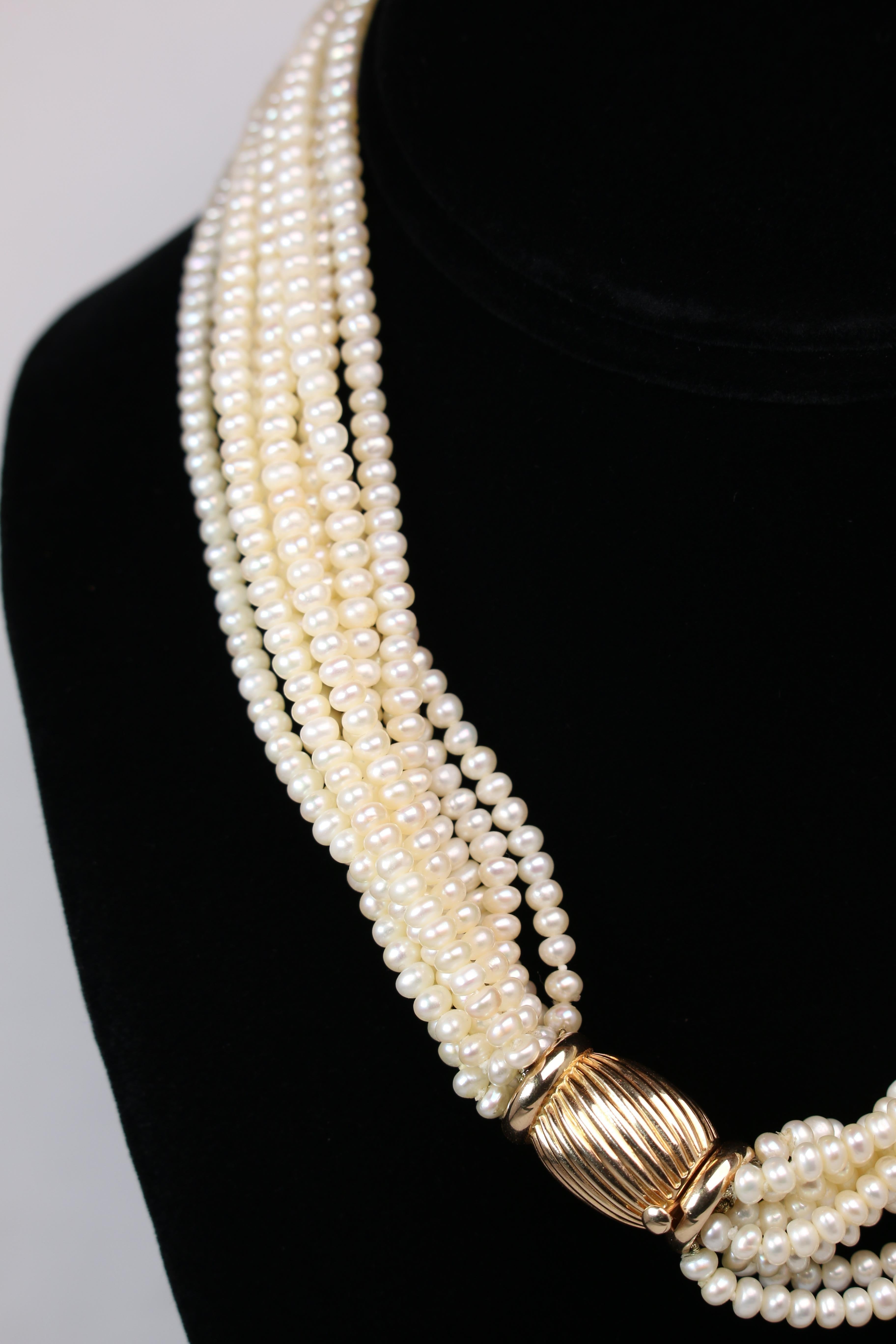 This stunning multi-strand pearl tots add necklace is fitted with a 14k Yellow Gold clasp. The necklace weighs in at 88.1 grams and is marked 14k 585