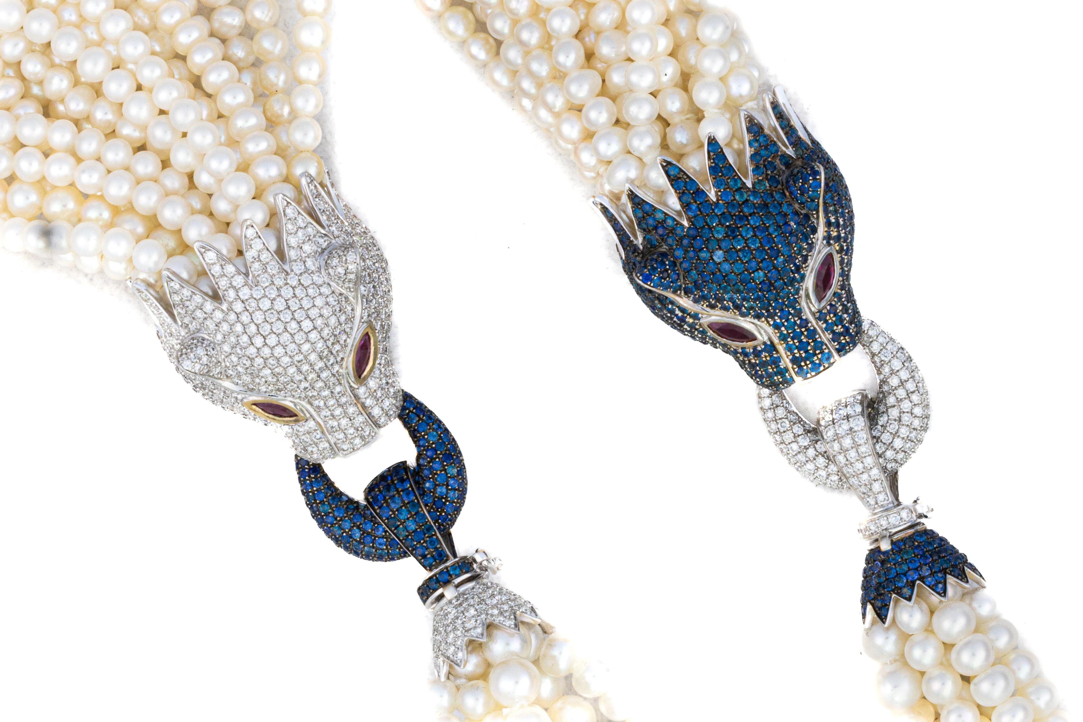 Multi-Strand Pearl Necklace with Diamond, Sapphire, and Ruby Panther Clasps

Description:
An impressive necklace composed of multiple strands of luminous pearls, joined by two intricately designed panther clasps. Each clasp is set with pavé