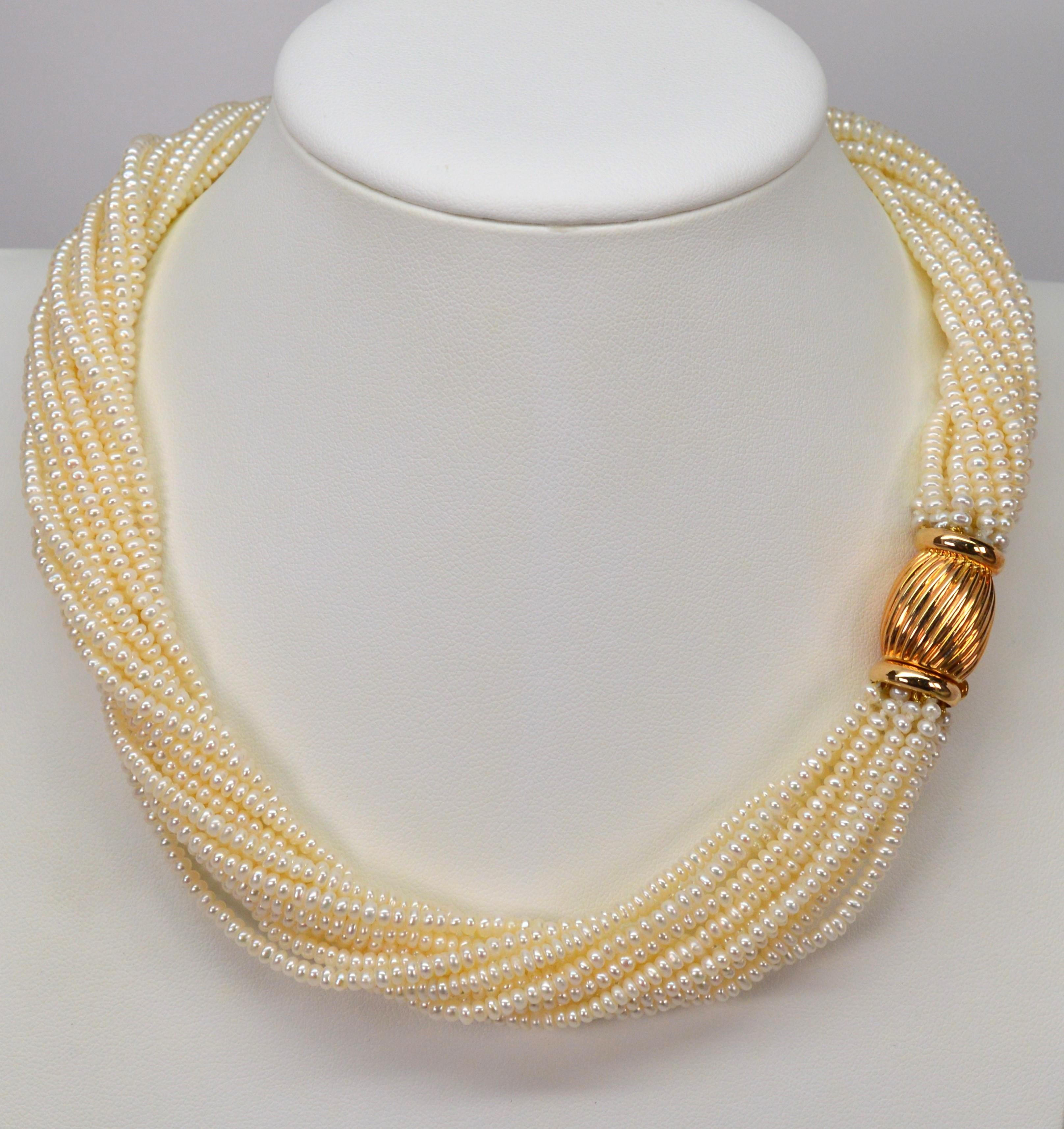 Classic pearls with a twist. Multiple strands of lustrous pearls accented with decorative 14 karat yellow gold bow tie clasp create this sophisticated 15-1/2 inch versatile necklace. Expertly matched 2.8mm lustrous cultured off-round pearls are hand