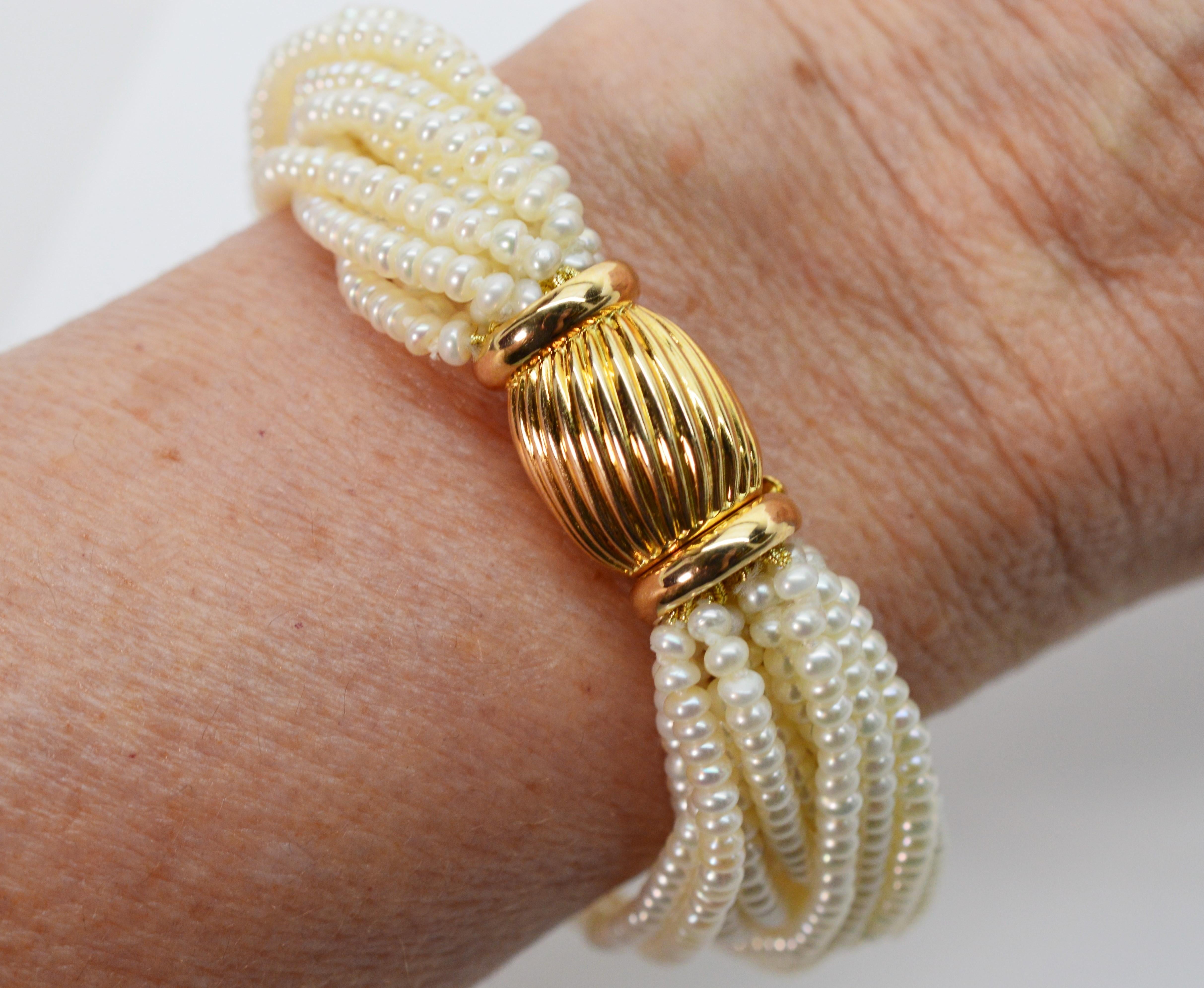 A sophisticated twist with fourteen strands of freshwater 2.50-2.75mm button AAA pearls wrap the wrist and creates this stunning bracelet. The decorative fourteen karat 14K yellow gold bowtie clasp adds elegance and can be worn to the front or