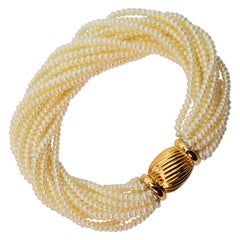 Multi Strand Pearl Wrap Bracelet with Decorative Yellow Gold Bow Tie Clasp