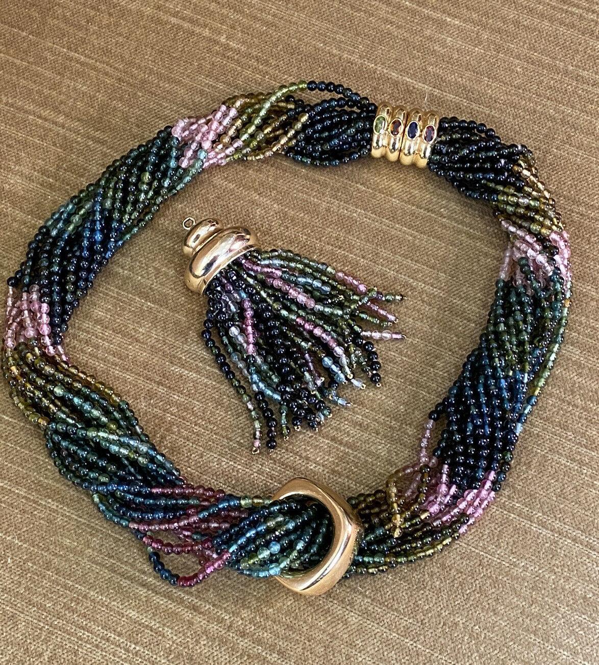 Multi-Strand Tourmaline Bead Necklace Detachable Tassel in 18k Yellow Gold

Multi-Strand Tourmaline Necklace features 14 strands of Tourmaline beads with a beautiful gradient of colors from light green to dark green and pink beads, accented by an