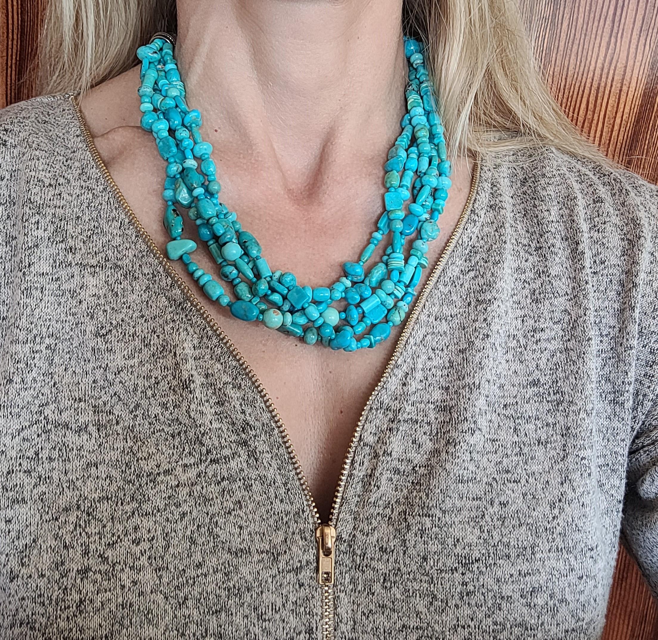 Lovely 20-inch multi-strand turquoise necklace with five beautiful strands of vivid blue beads attached to a decorative silver clasp secured with a lobster clasp. Overall this necklace is in very good condition. Please let us know if you have any