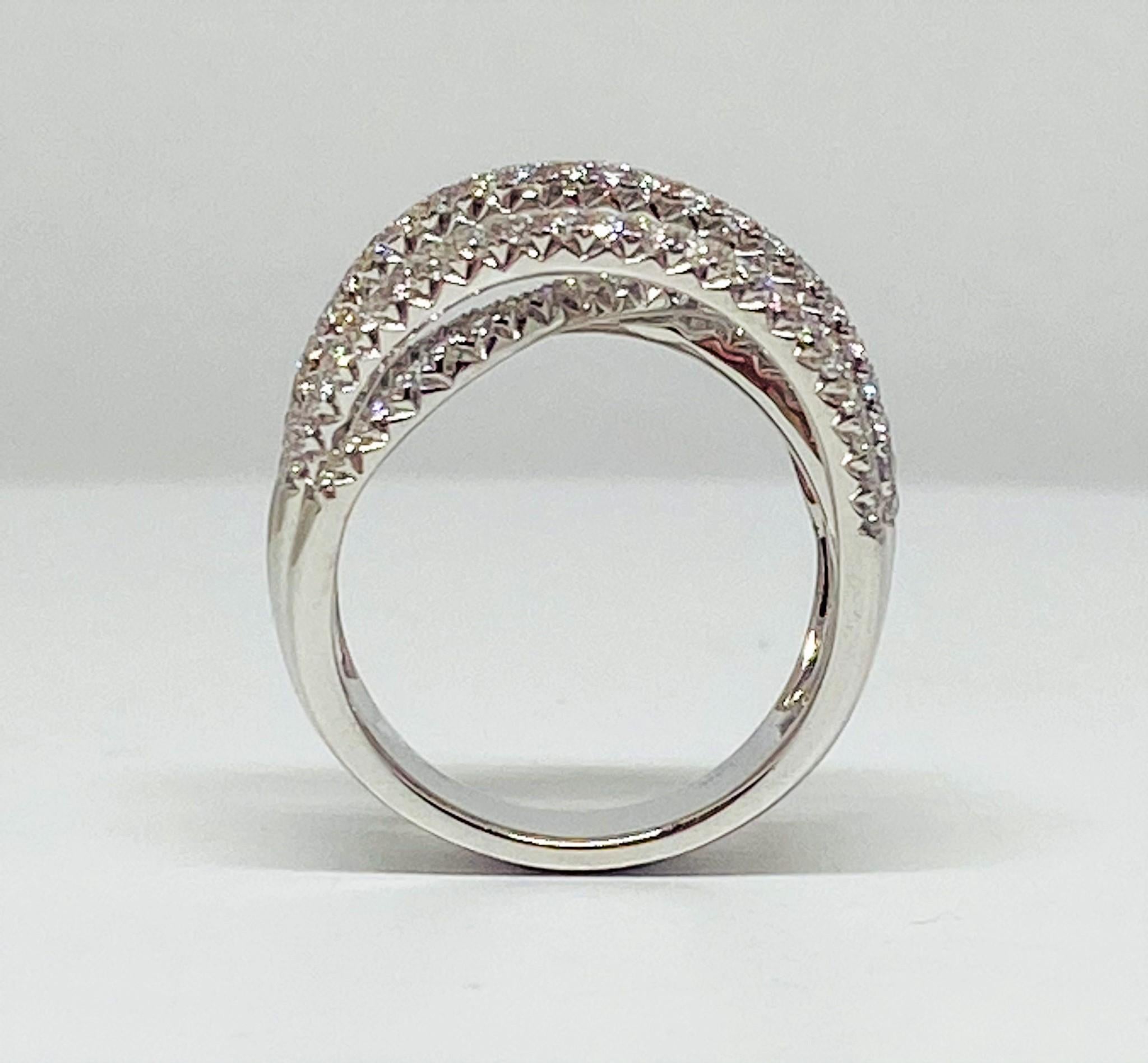Classy contemporary style ring featuring an open weave of multiple strands of pave set white diamonds weighing a total of 1.98 carats set on a white band all in 14KT white gold. 
