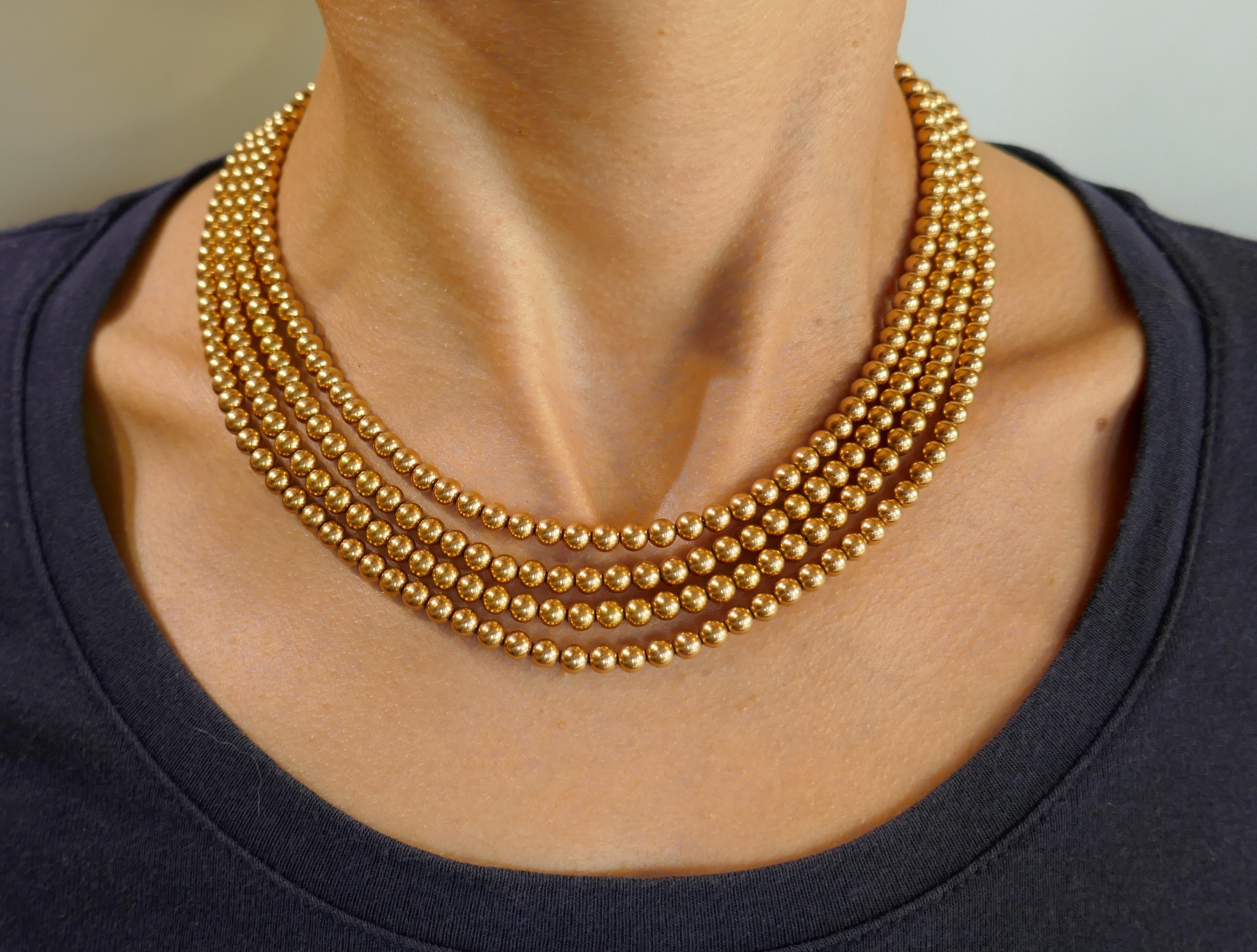 Lovely multi-strand gold bead necklace. Features four strands of yellow gold beads. Elegant, feminine and wearable, the necklace is a great addition to your jewelry collection.
The shortest strand is 15 inches (38 centimeters) long, the longest