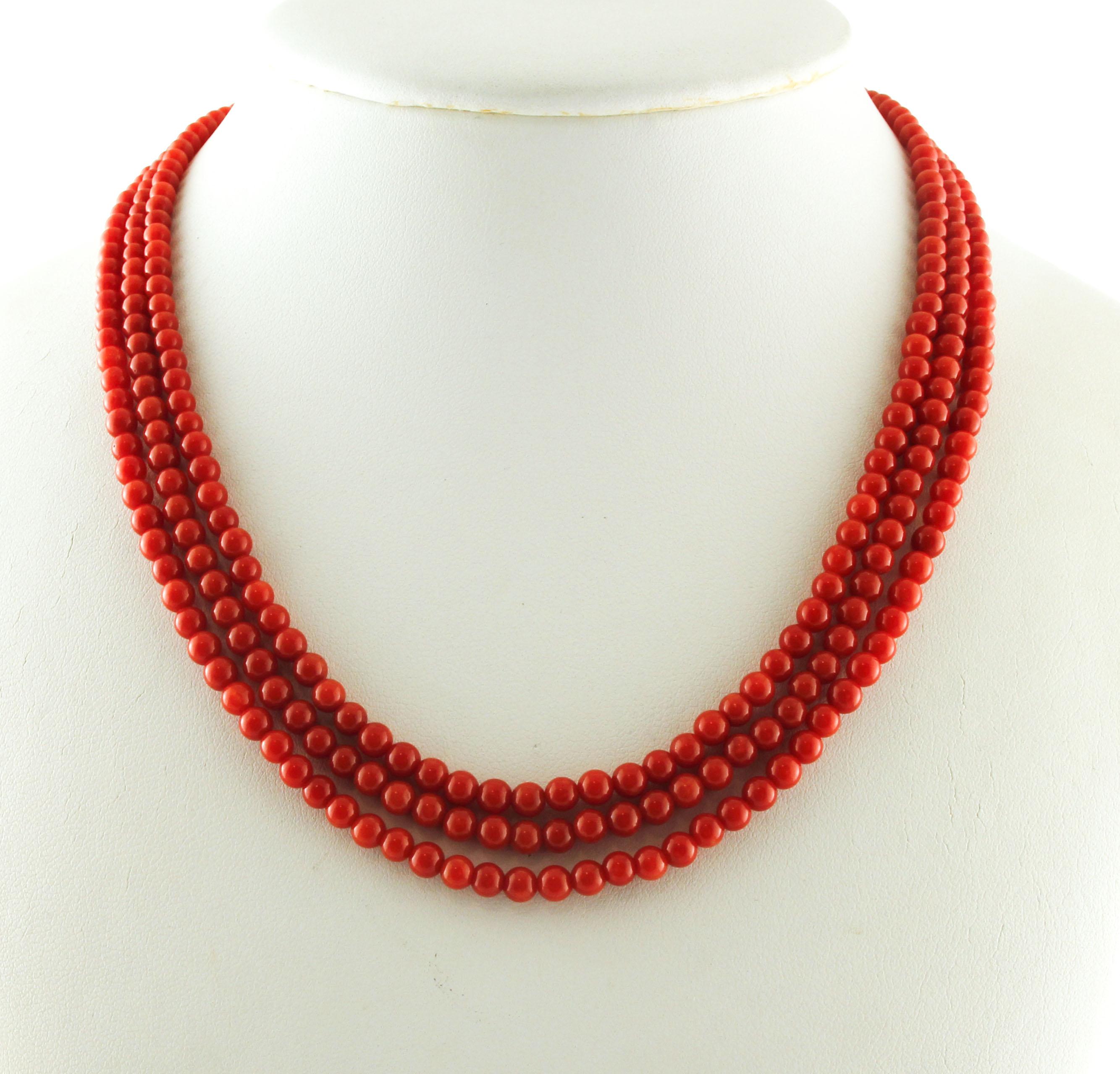 Beautiful multi-strands beaded coral necklace, realized with 3 rows of red rubrum coral spheres, for a total of 29.67 g of coral. The simple closure is realized in 18k yellow gold. 
This necklace is totally handmade by Italian master