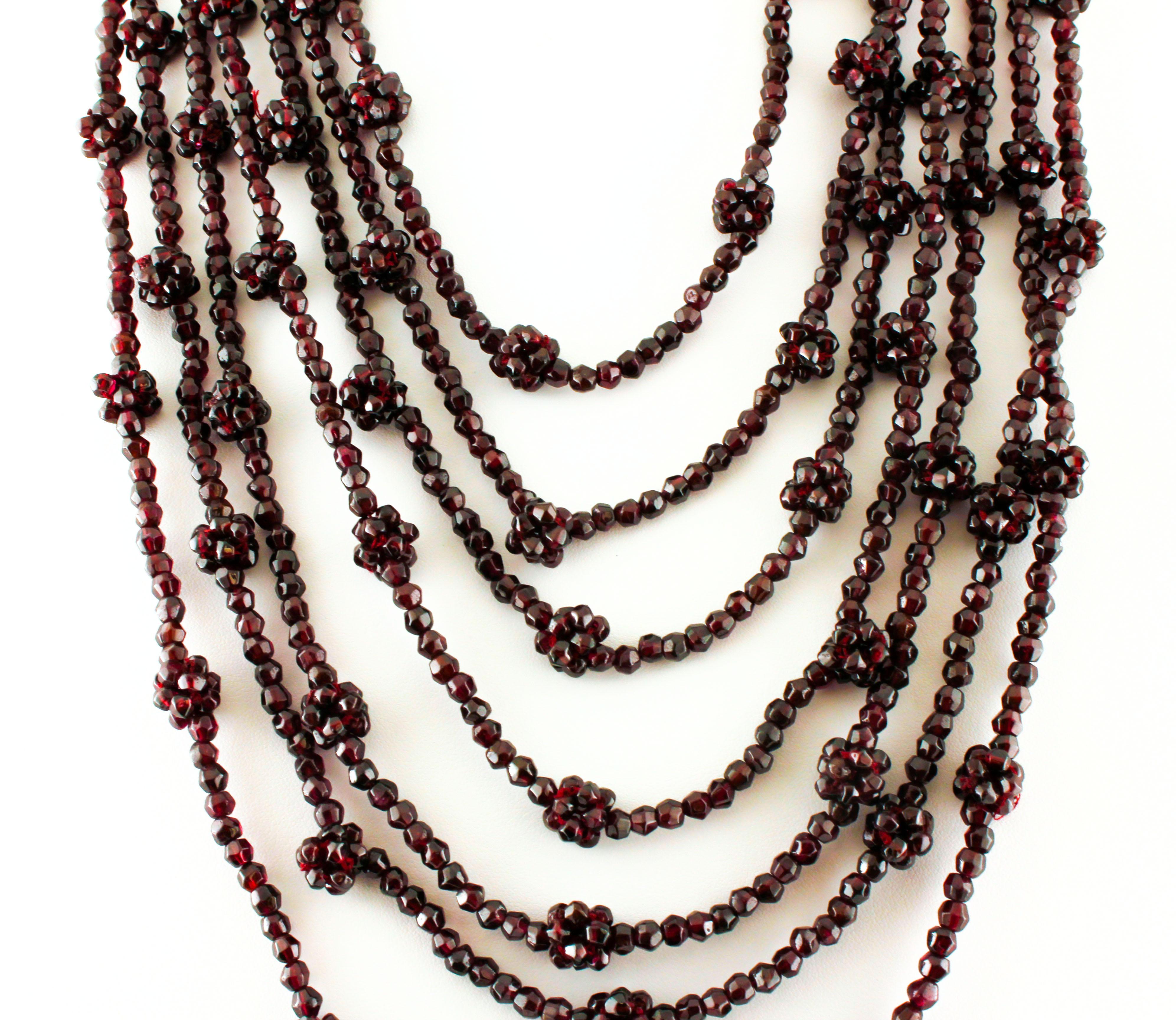 Marvelous multi-strands beaded necklace realized with 7 strands of 354.40 g of garnet beads and a simple golden silver clasp. 
The origin of this necklace goes back to 1960s. It was totally handmade by Italian master goldsmiths and it is in perfect