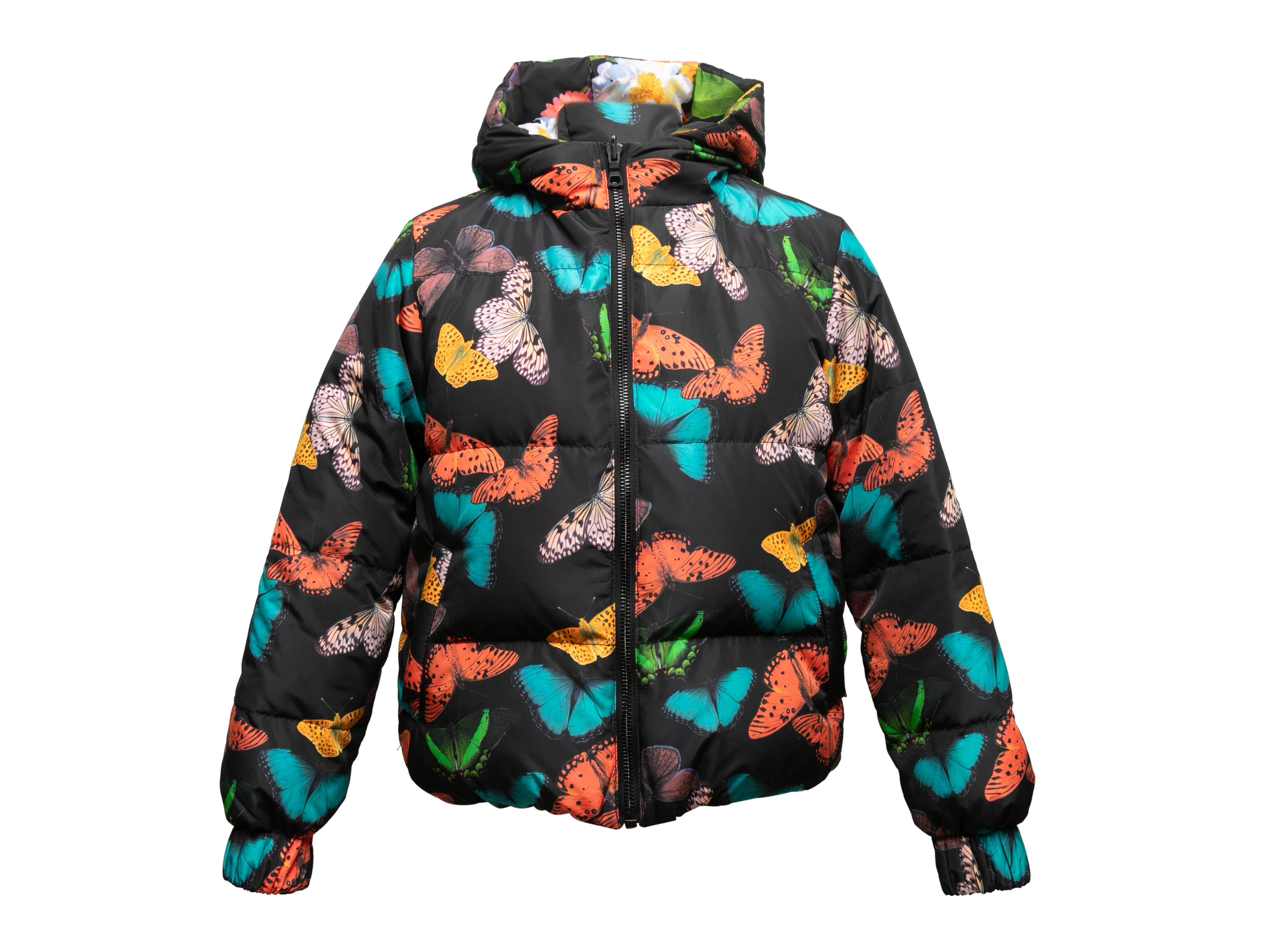 Multicolor reversible butterfly and floral print hooded puffer jacket by Alice + Olivia. Dual hip pockets. Front zip closure. 38