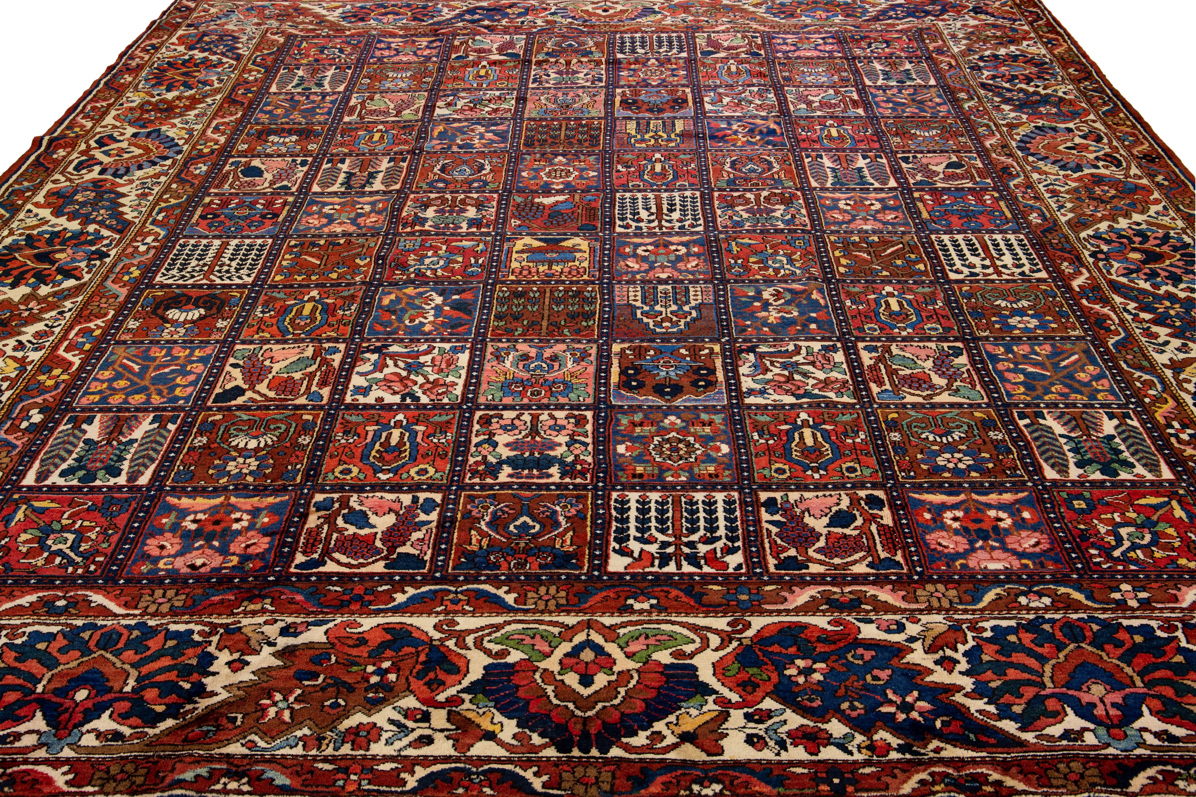 Beautiful Antique Bakhtiari hand-knotted wool rug with a multicolor field. This Persian piece has an all-over classic pattern design.

This rug measures 13'5