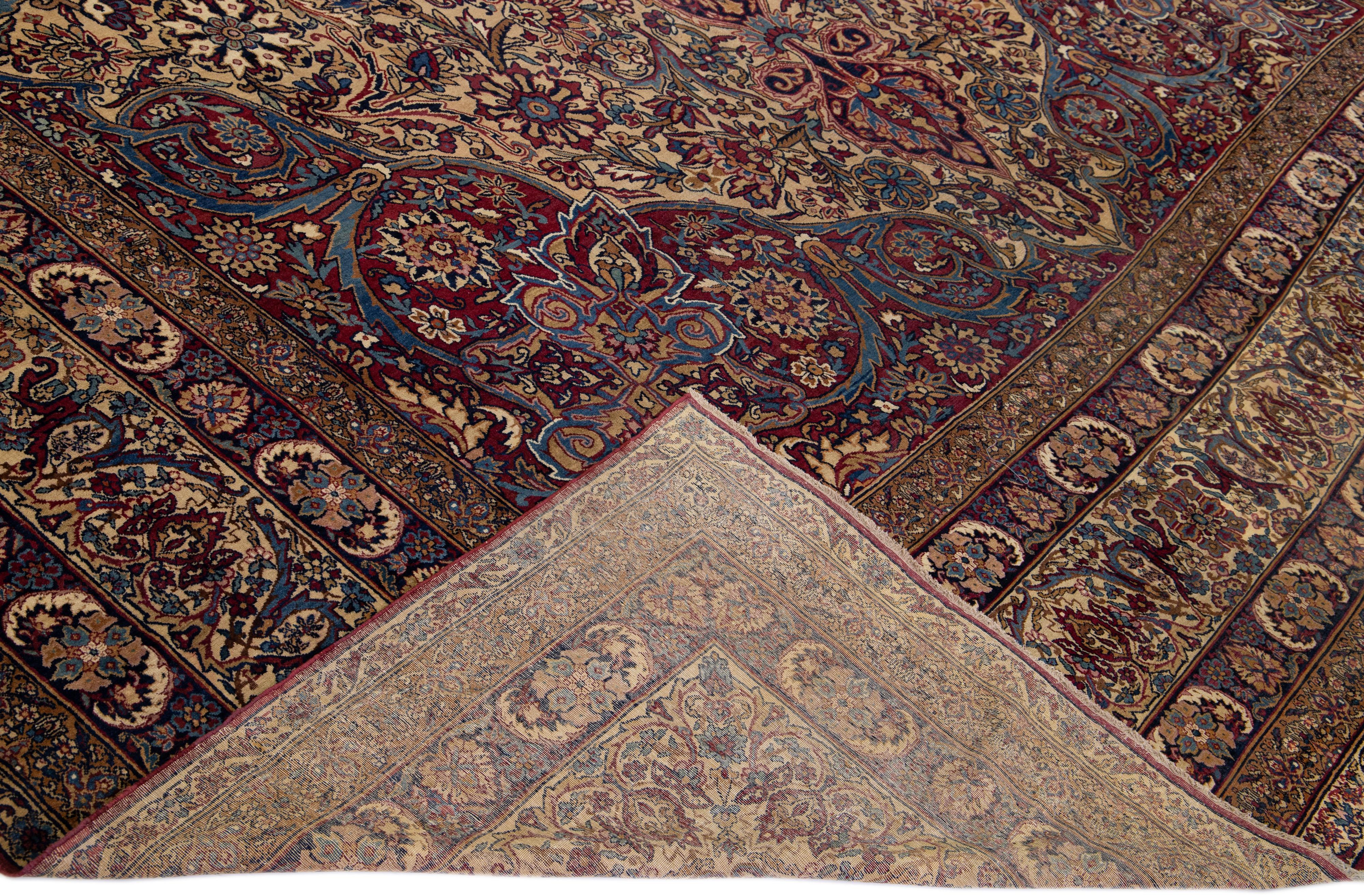 Beautiful antique Kerman hand-knotted wool rug with a beige field. This Persian rug has multicolor accents in a gorgeous all-over medallion floral pattern design.

This rug measures: 12'7