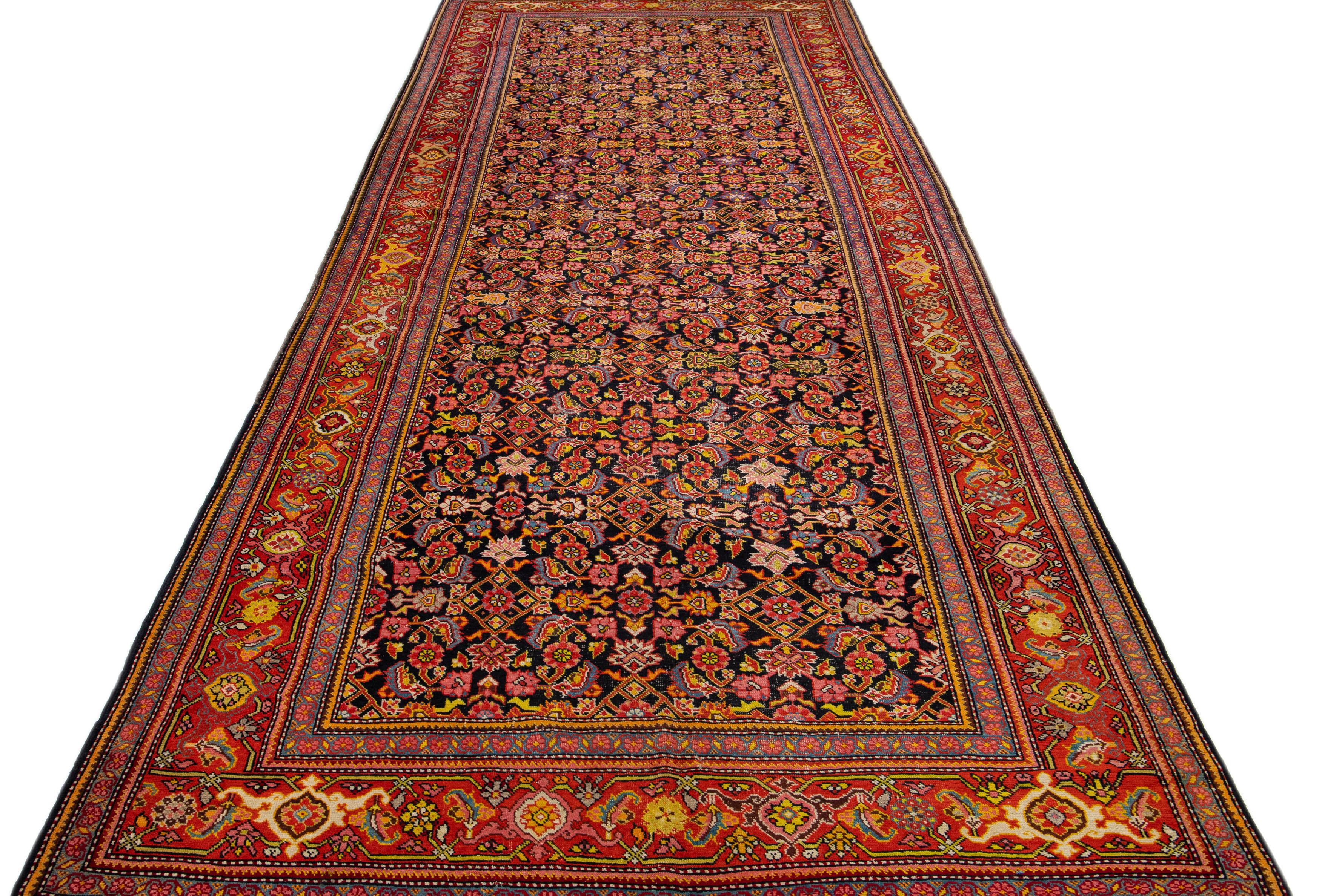 Beautiful antique Malayer Persian rug with a dark blue field. This piece has a designed frame with multicolor accents in an all-over floral design. 

This rug measures: 6'7