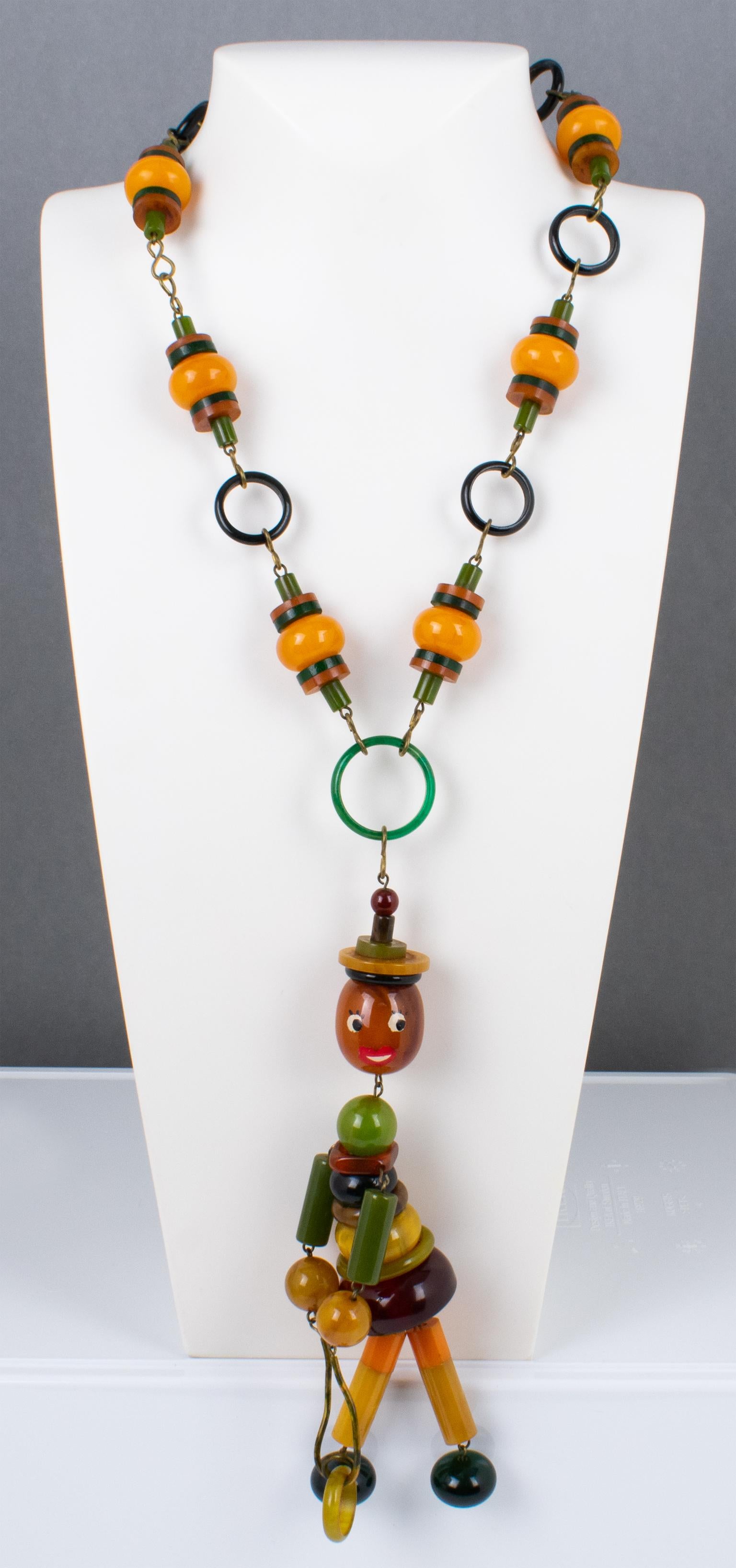 Art Deco Multicolor Bakelite Long Necklace with Articulated Crib Toy Doll Pendant, 1940s For Sale