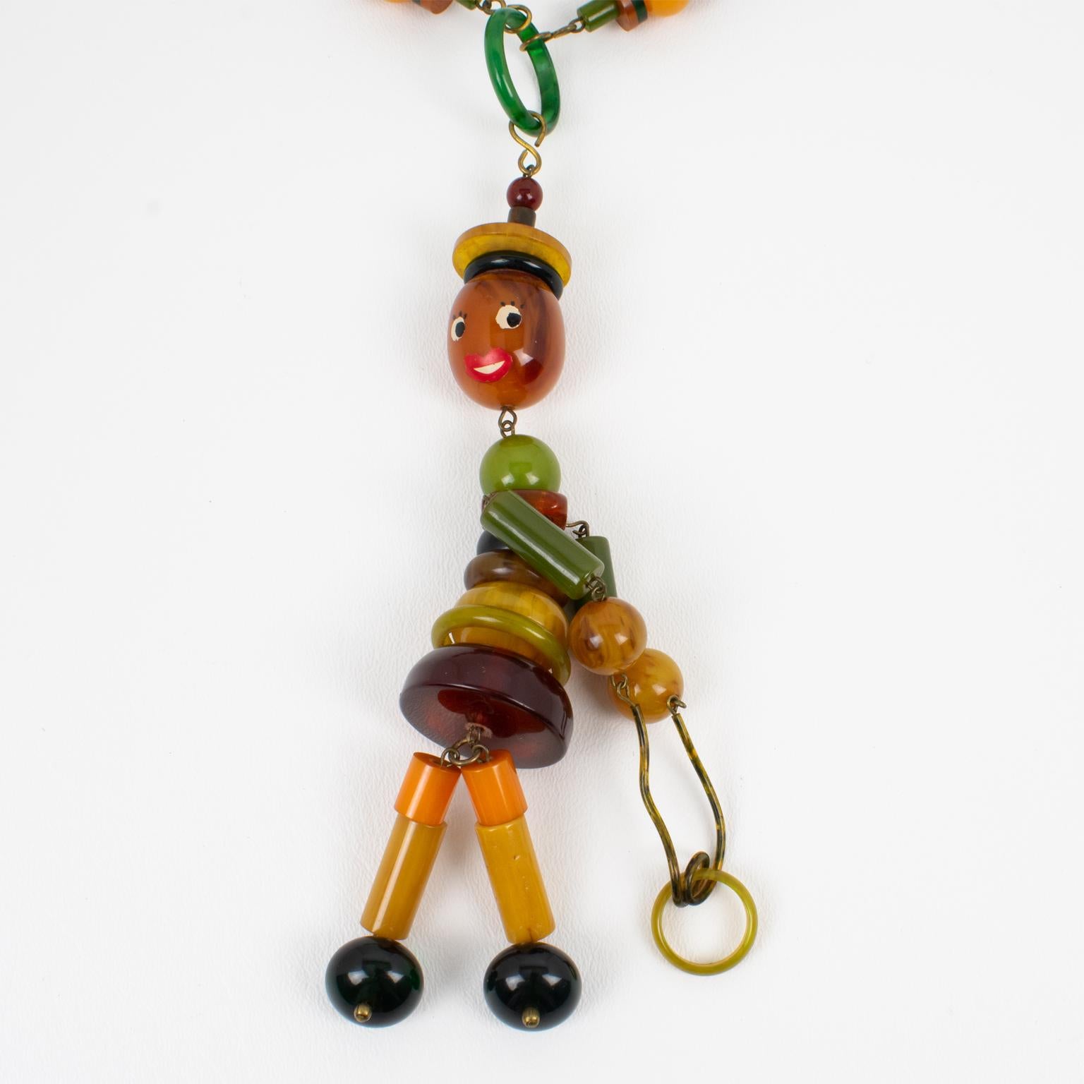 Multicolor Bakelite Long Necklace with Articulated Crib Toy Doll Pendant, 1940s In Excellent Condition For Sale In Atlanta, GA