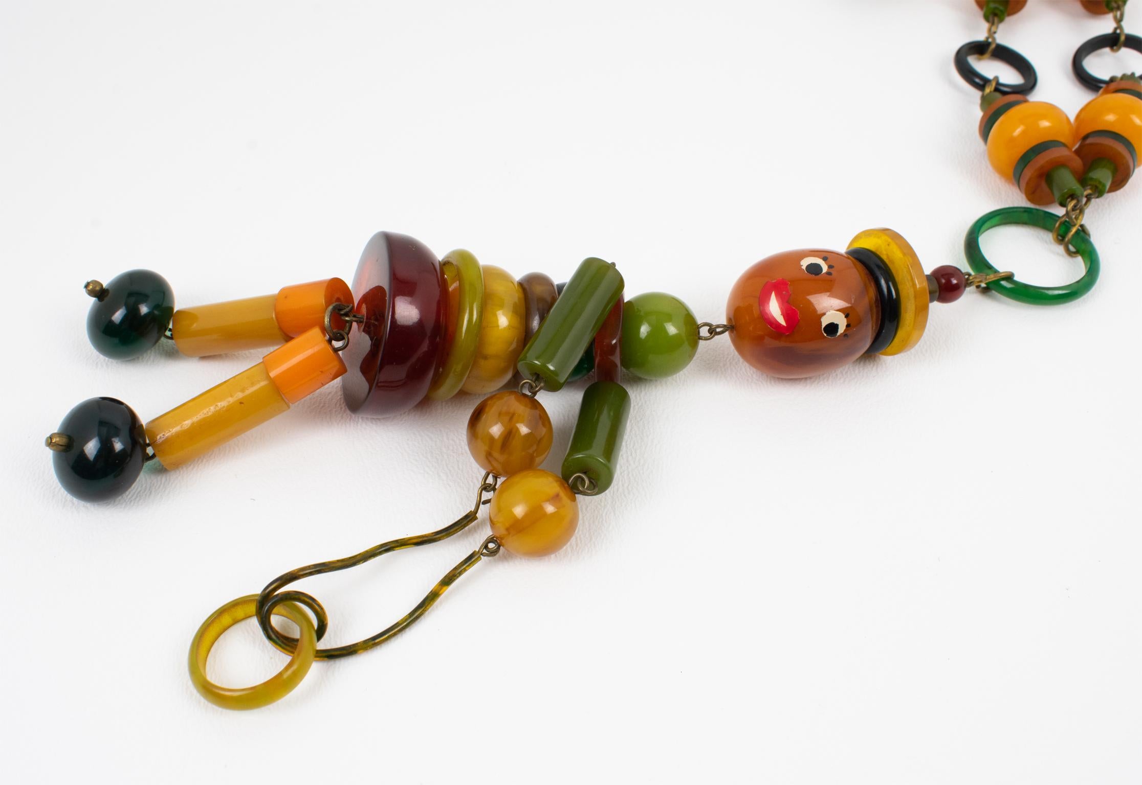 Women's Multicolor Bakelite Long Necklace with Articulated Crib Toy Doll Pendant, 1940s For Sale