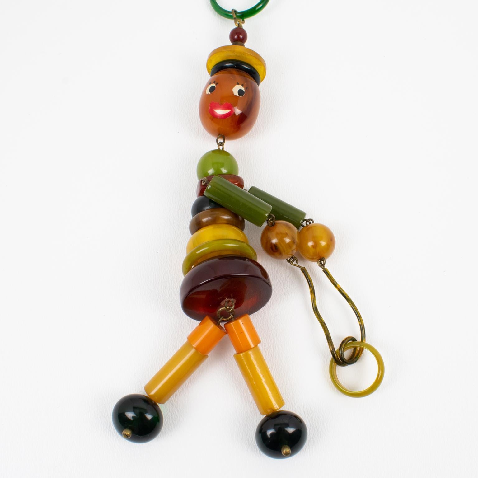 Multicolor Bakelite Long Necklace with Articulated Crib Toy Doll Pendant, 1940s For Sale 2