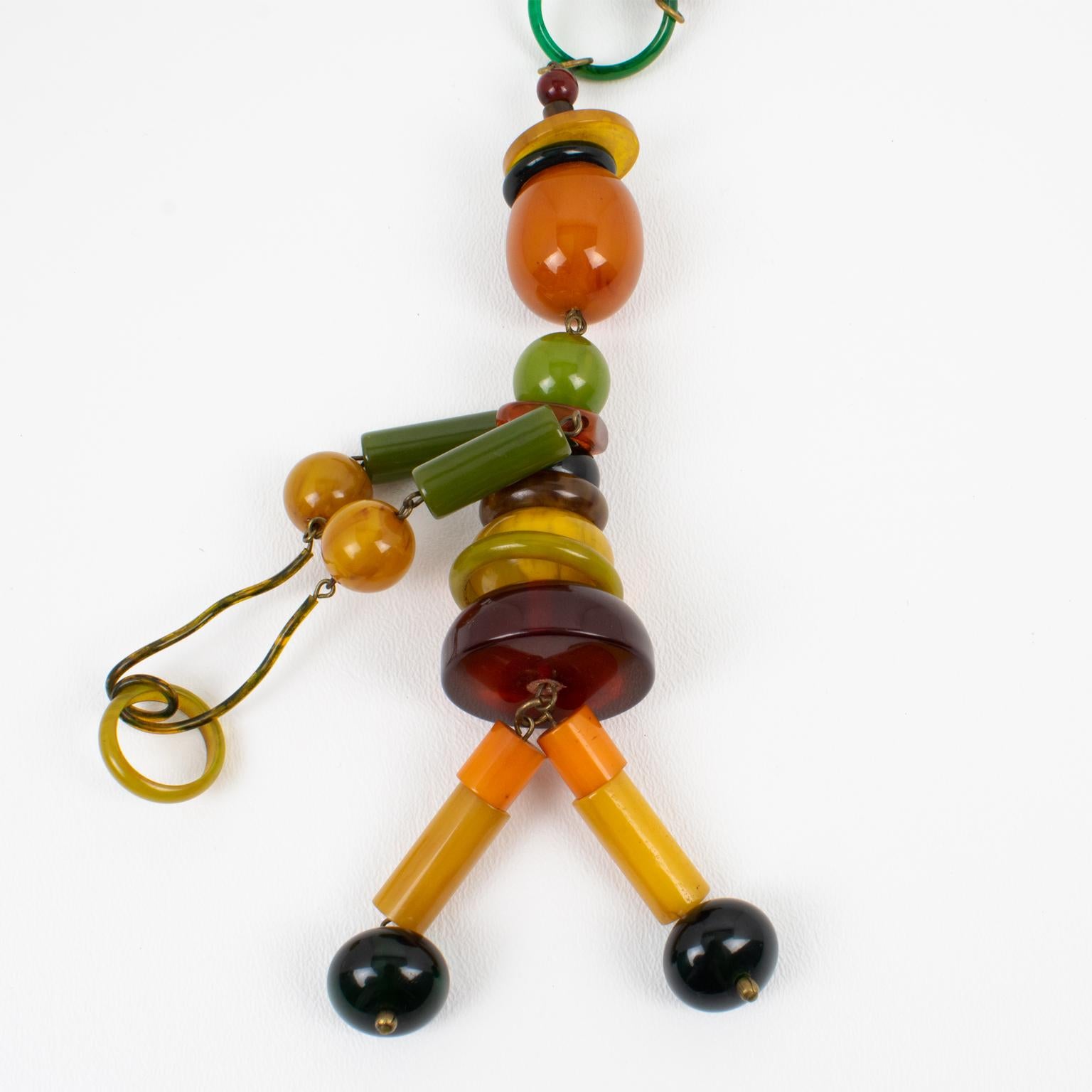 Multicolor Bakelite Long Necklace with Articulated Crib Toy Doll Pendant, 1940s For Sale 3