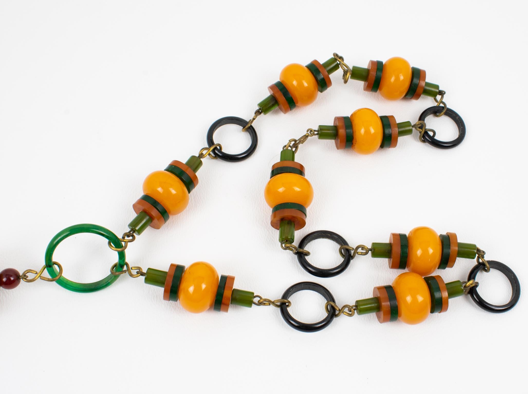 Multicolor Bakelite Long Necklace with Articulated Crib Toy Doll Pendant, 1940s For Sale 4