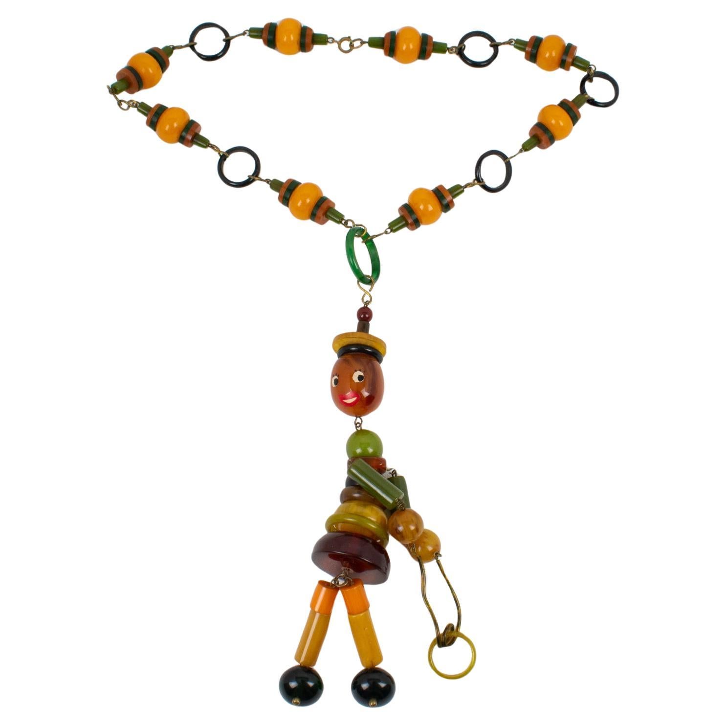 Multicolor Bakelite Long Necklace with Articulated Crib Toy Doll Pendant, 1940s For Sale