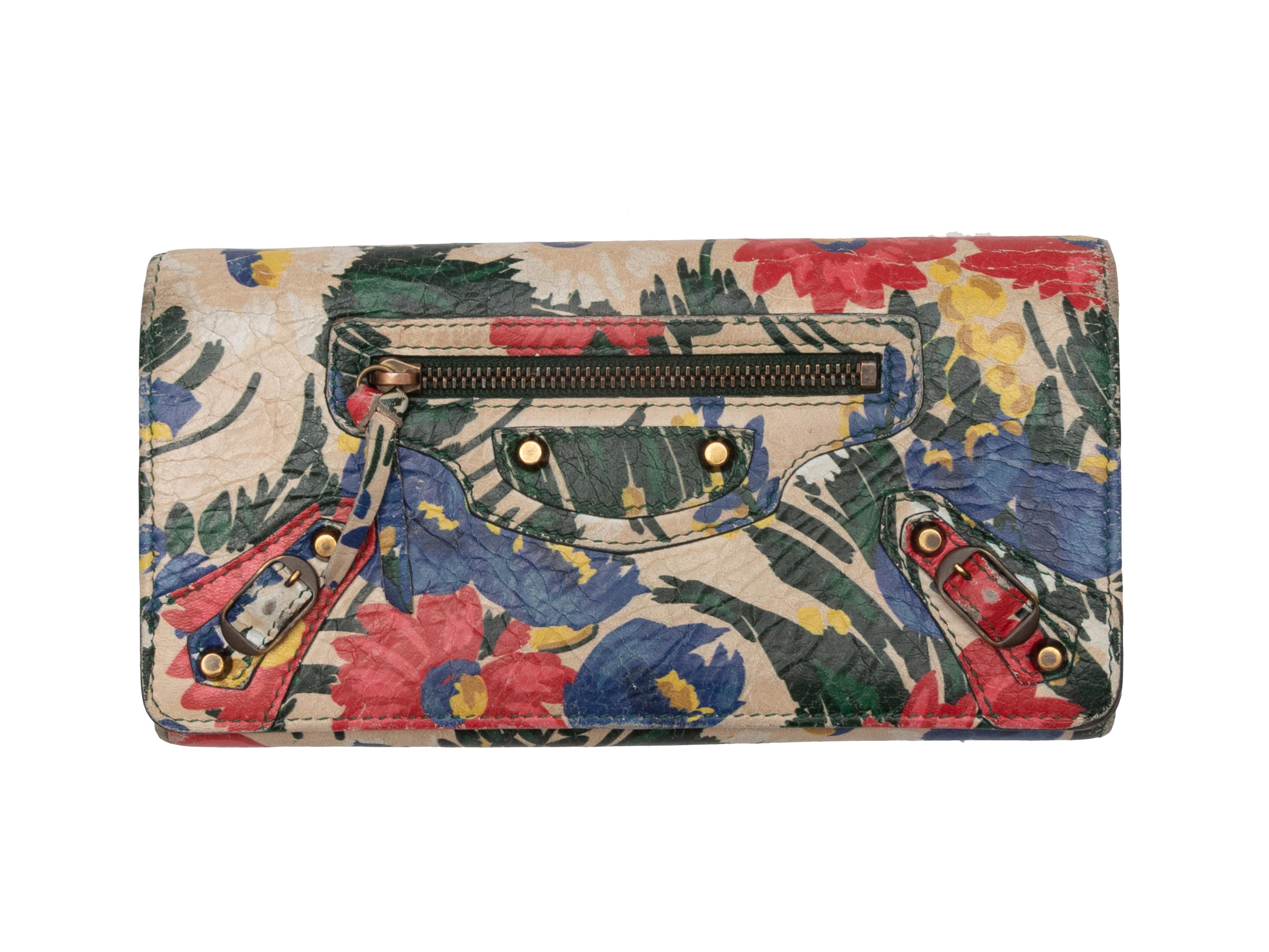Product Details: Multicolor floral print leather moto wallet by Balenciaga. Gold-tone hardware. Multiple interior card and cash slots. Front zip closure pocket. Front flap closure. 4