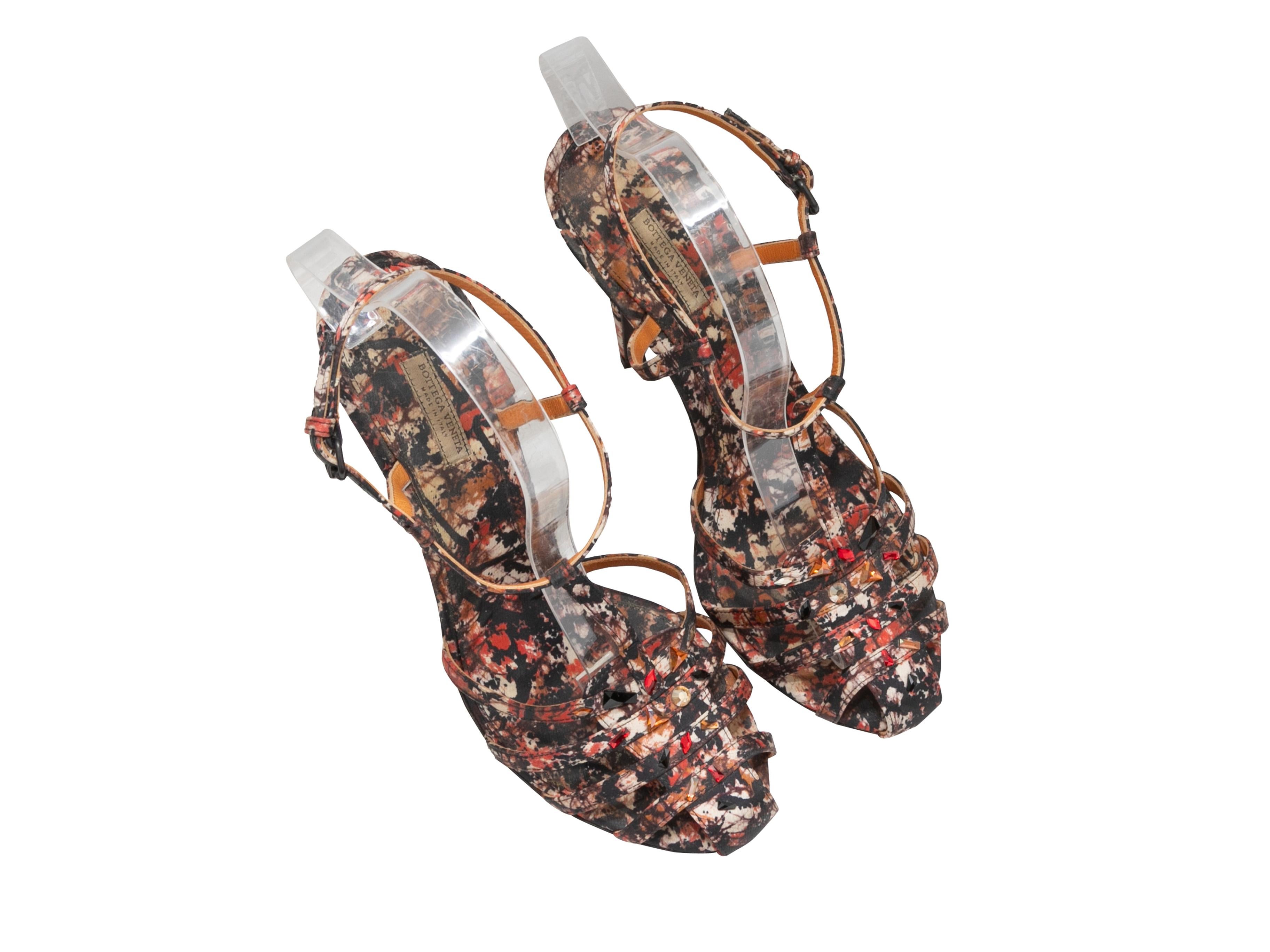 Product Details: Multicolor satin printed T-strap heels by Bottega Veneta. Jewel embellishments at tops. Buckle closures at ankle straps. 4.75