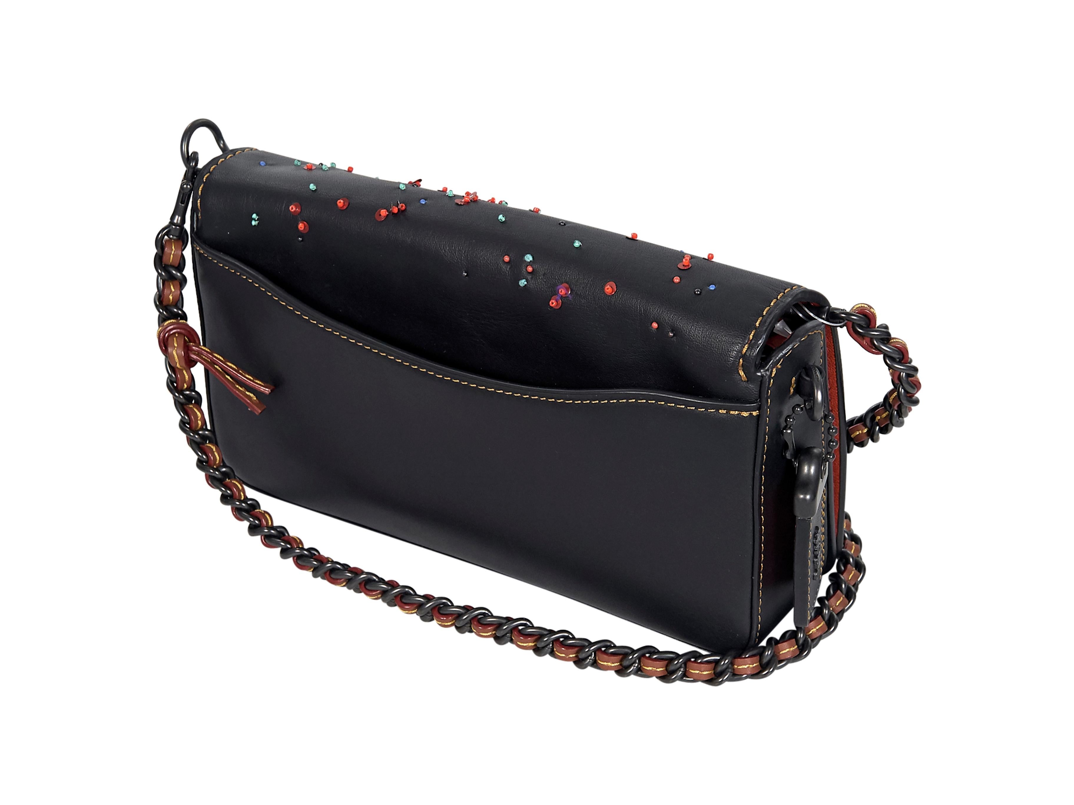 Product details:  Multicolor beaded and embroidered leather crossbody bag by Coach.  Detachable crossbody chain.  Front flap with twist-lock closure.  Leather interior with inner attached coin pouch.  Back exterior slide pocket.  Black hardware. 