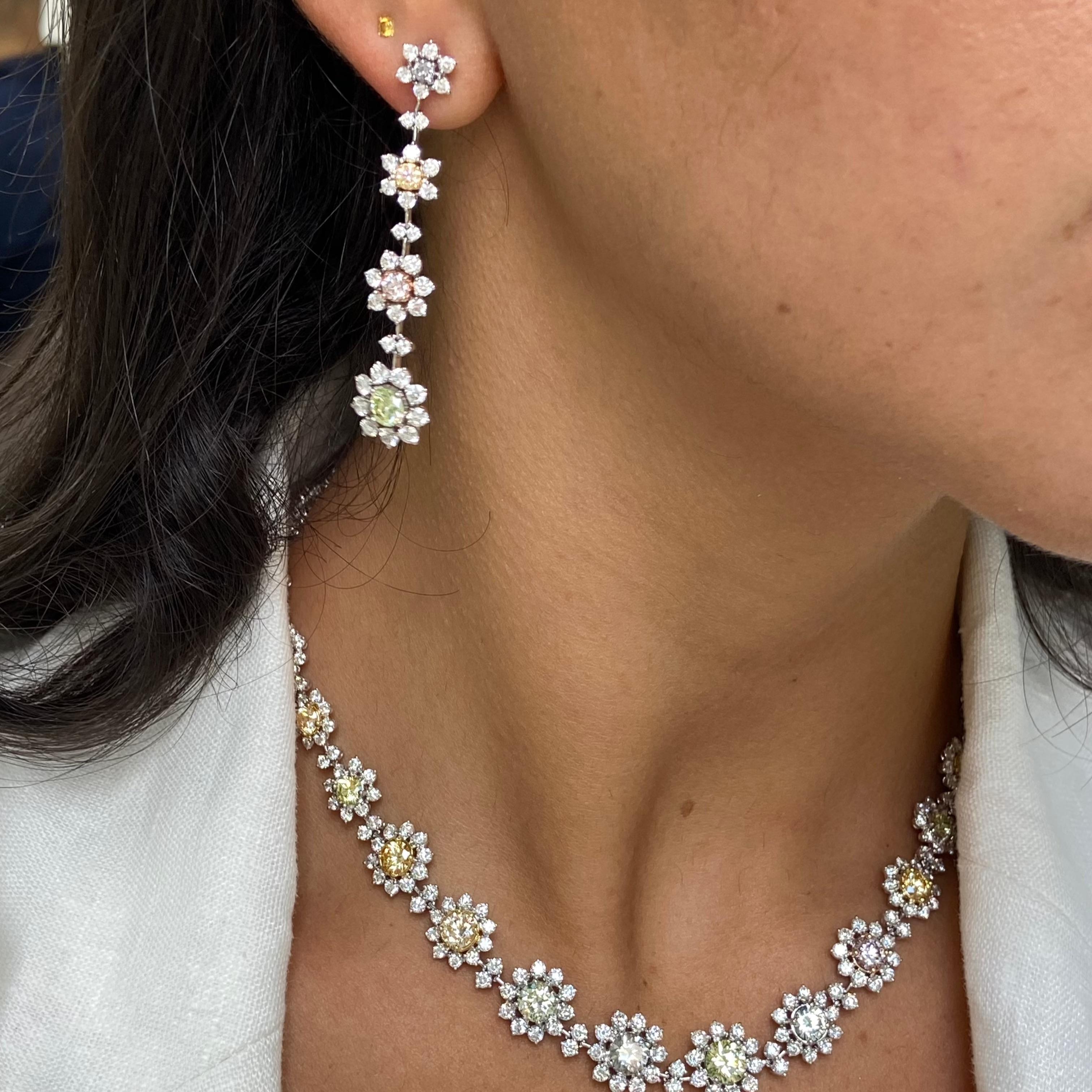 These elegant Multicolor Diamond Flower Drop Earrings feature 4.98 total carats of both multicolor and white diamonds. Matching necklace available. 

Crafted in 18k white gold and handmade in NYC, they showcase 8 GIA-certified natural diamonds in